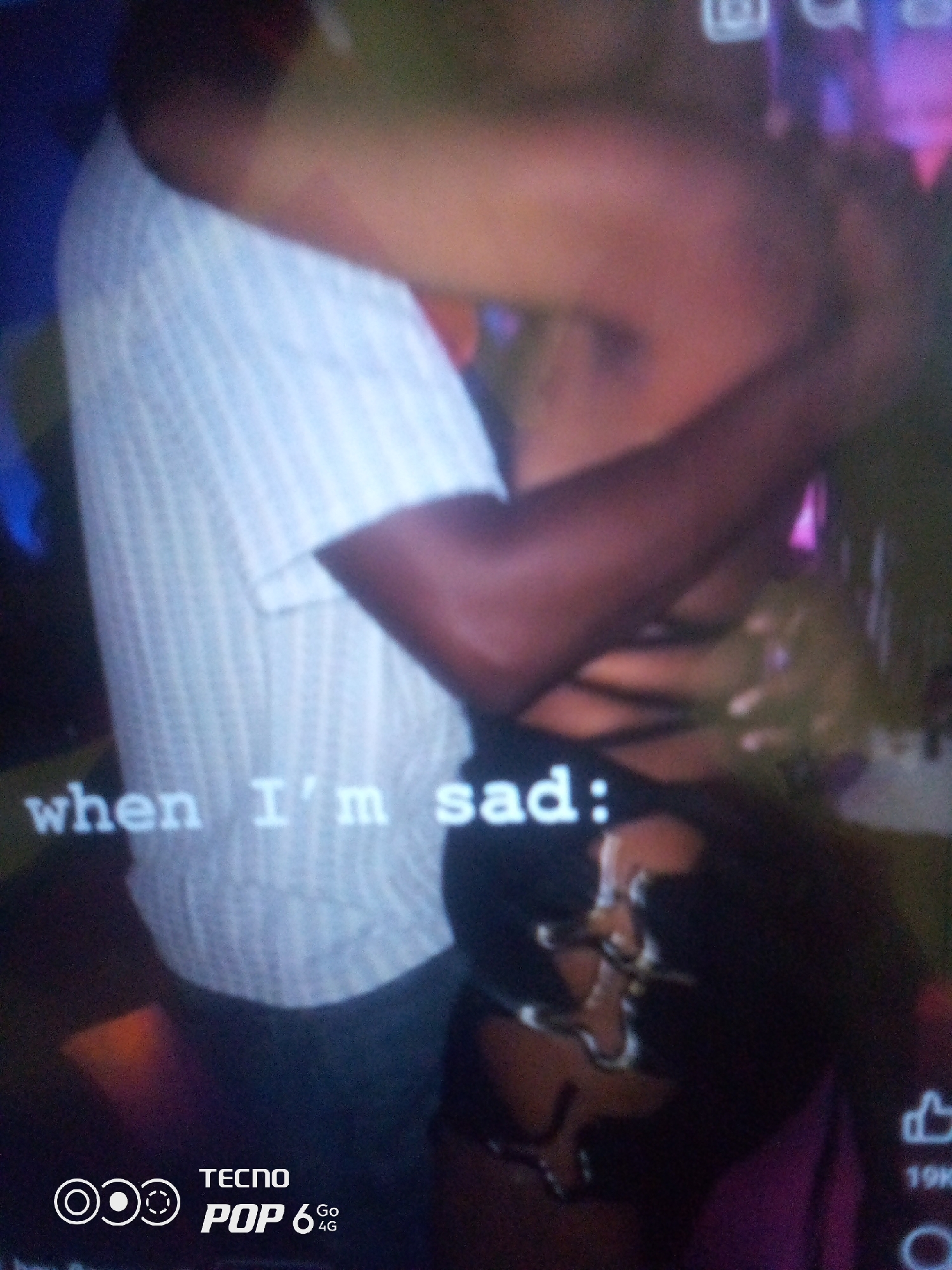 In Howayi, Nigeria, a close-up shot shows two individuals embracing. One person, wearing a white striped shirt, has their arms wrapped around the other. The second individual, partially obscured, wears dark clothing with strap details. White text overlaying the image reads "when I'm sad:". The bottom left corner displays the TECNO POP 6 4G logo.