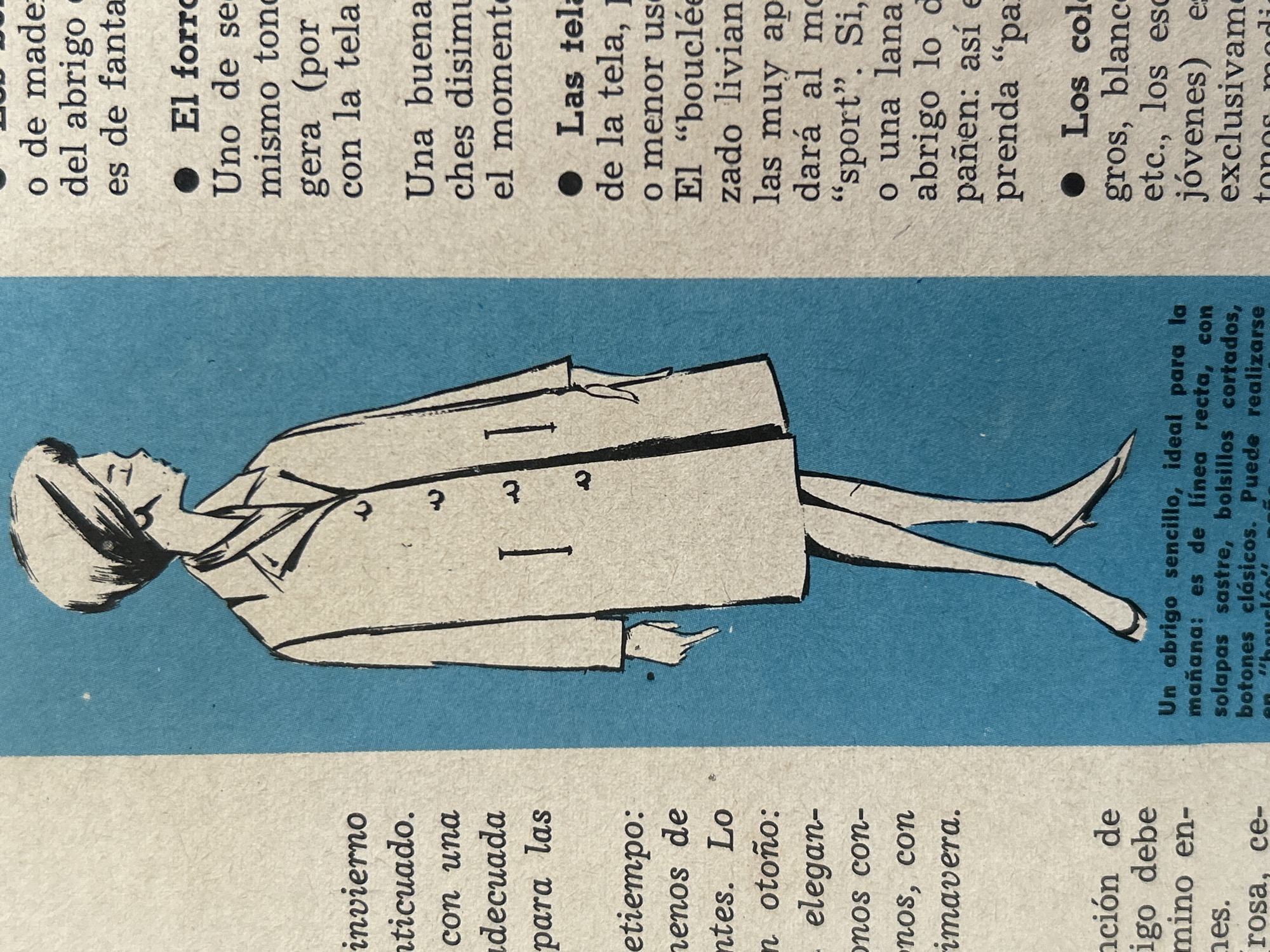 The image shows a fashion illustration of a woman wearing a coat. The illustration is on the left side of the image, with text on both the left and right sides of the illustration, printed on what appears to be a magazine page. The background behind the illustration is a solid blue color. The text is in Spanish. The illustration depicts a woman in profile, facing left, with her hair in a bun. She is wearing a knee-length coat with a collar and lapels. The coat has two buttons visible on the right side and a pocket detail. Her legs are visible, and she is wearing high-heeled shoes. The text on the left side of the image discusses winter, autumn, and spring fashion. The text on the right side discusses coat linings, fabric types, and colors. There is no indication in the image that it is located in Santa Ana, Venezuela.
