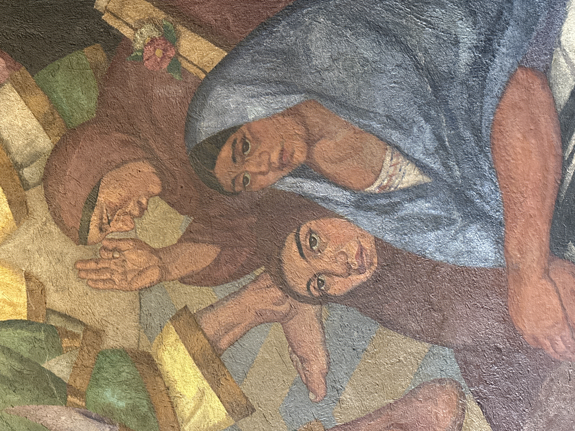 The image shows a detail of a mural in Mexico City, Mexico. It features three people rendered in a stylized, earthy color palette with visible brushstrokes. The person at the top right is seen with a blue head covering and is facing towards the left. Beside this person, to the upper left, is another, facing the same direction, with a flower near their head. Below these two, a third figure is depicted looking upward towards the viewer, its hand outstretched. The background appears to be a mosaic of geometric shapes in varying shades of brown, gold, and green.