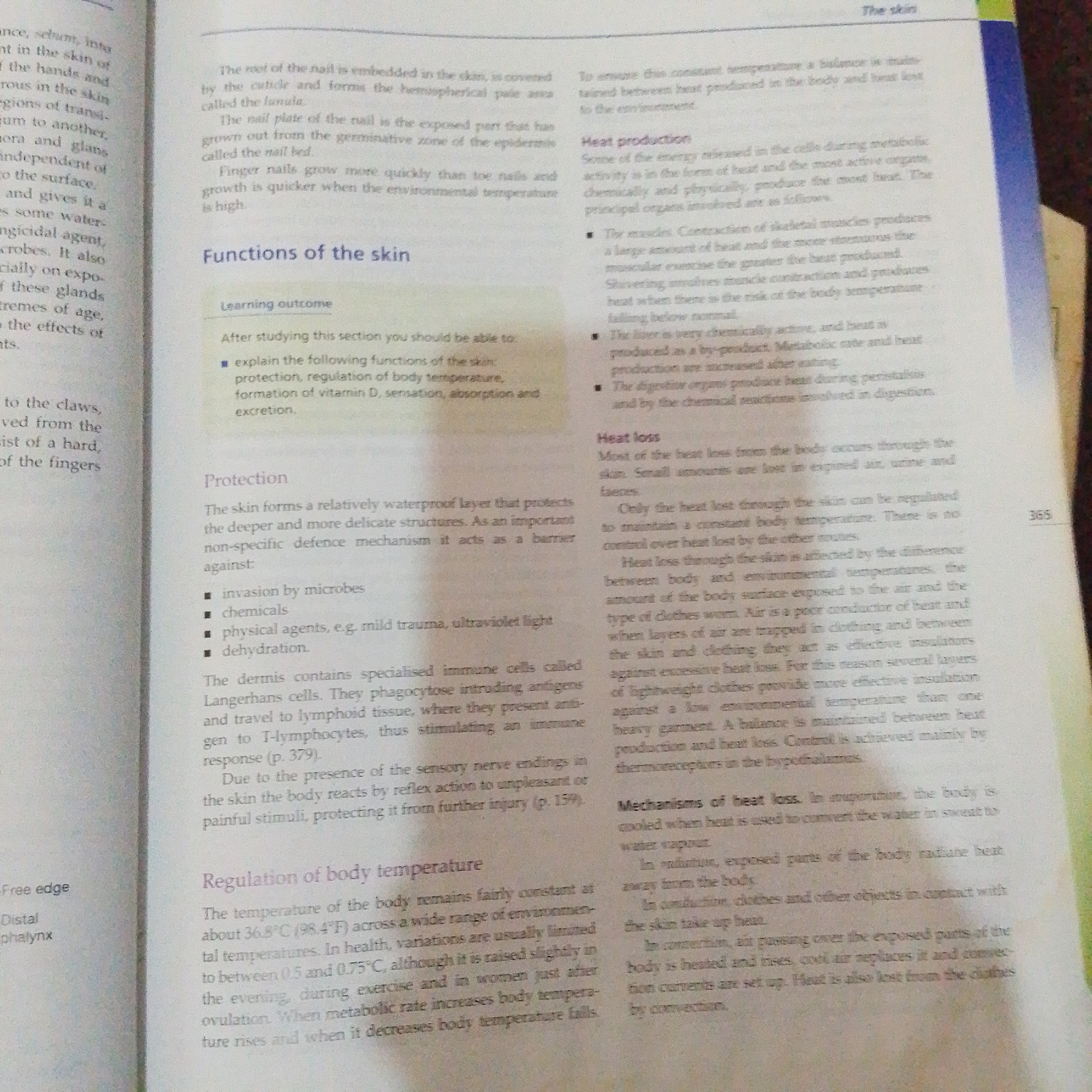 The image shows an open book with text and some illustrations. The book appears to be a textbook on biology or human anatomy, as evidenced by the chapter title "Functions of the skin" and sections on "Protection", "Heat production", "Heat loss", and "Regulation of body temperature". The text is in English. There are no visual elements that suggest a location in Jalingo, Nigeria, or any urban setting. The image is a close-up of a page in a book, with no people, objects, actions, or interactions depicted outside of the text and illustrations within the book.