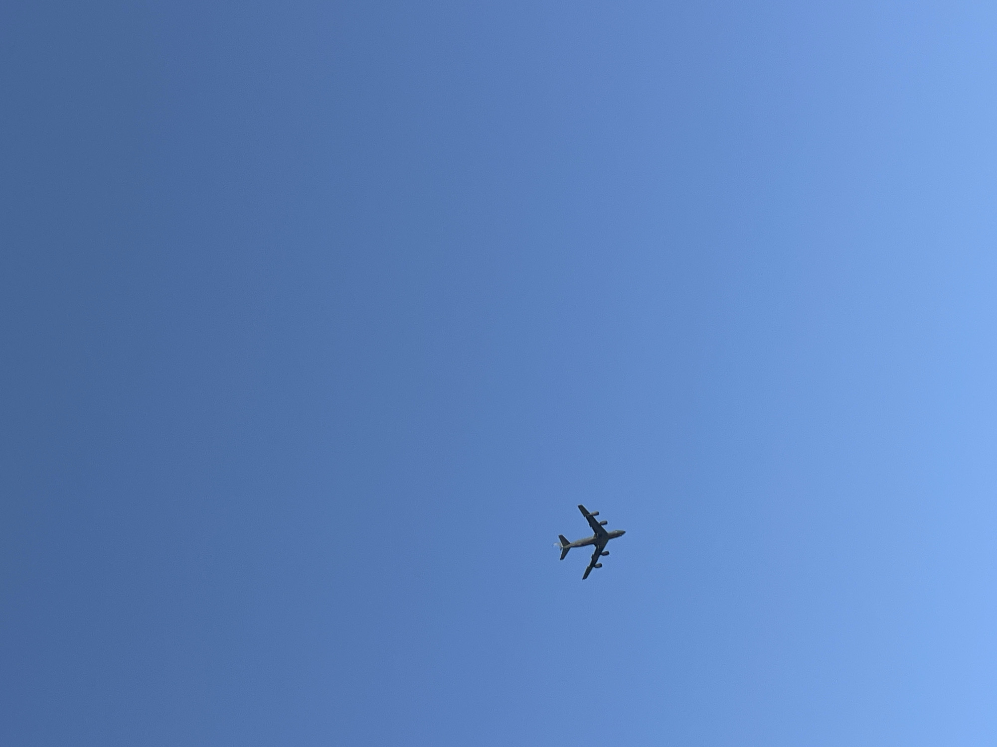 A B-52 Stratofortress aircraft flies in a clear blue sky above Tel Aviv, Israel.
