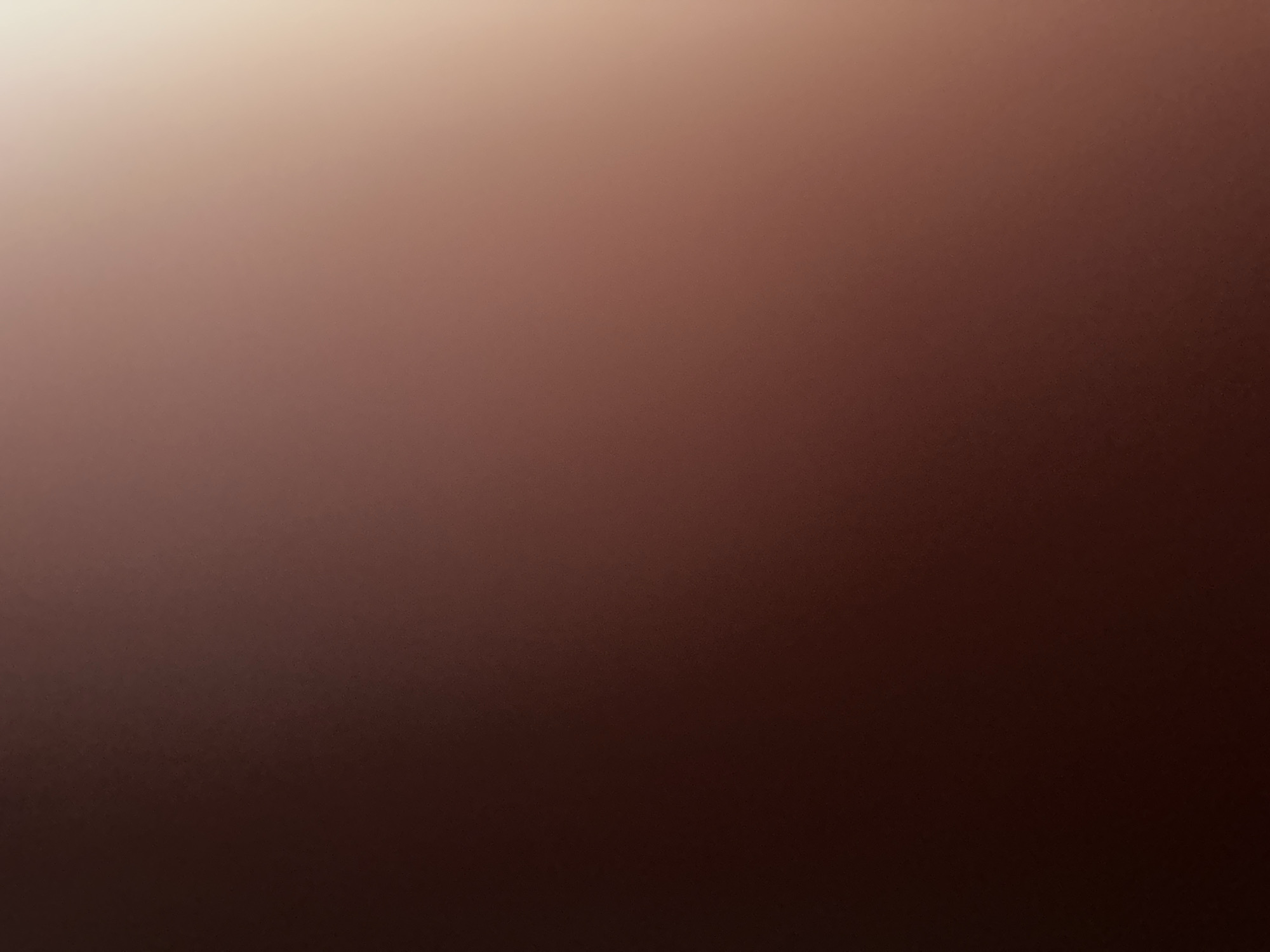 The image is a blurred, abstract gradient of colors, transitioning from a dark reddish-brown on the left to a lighter, almost golden hue on the right. There are no discernible objects, people, or specific environmental features, making it impossible to determine a location in Belgrade, Serbia, or any other specific place. The image lacks any concrete details that would allow for a forensic or matter-of-fact description of a scene.