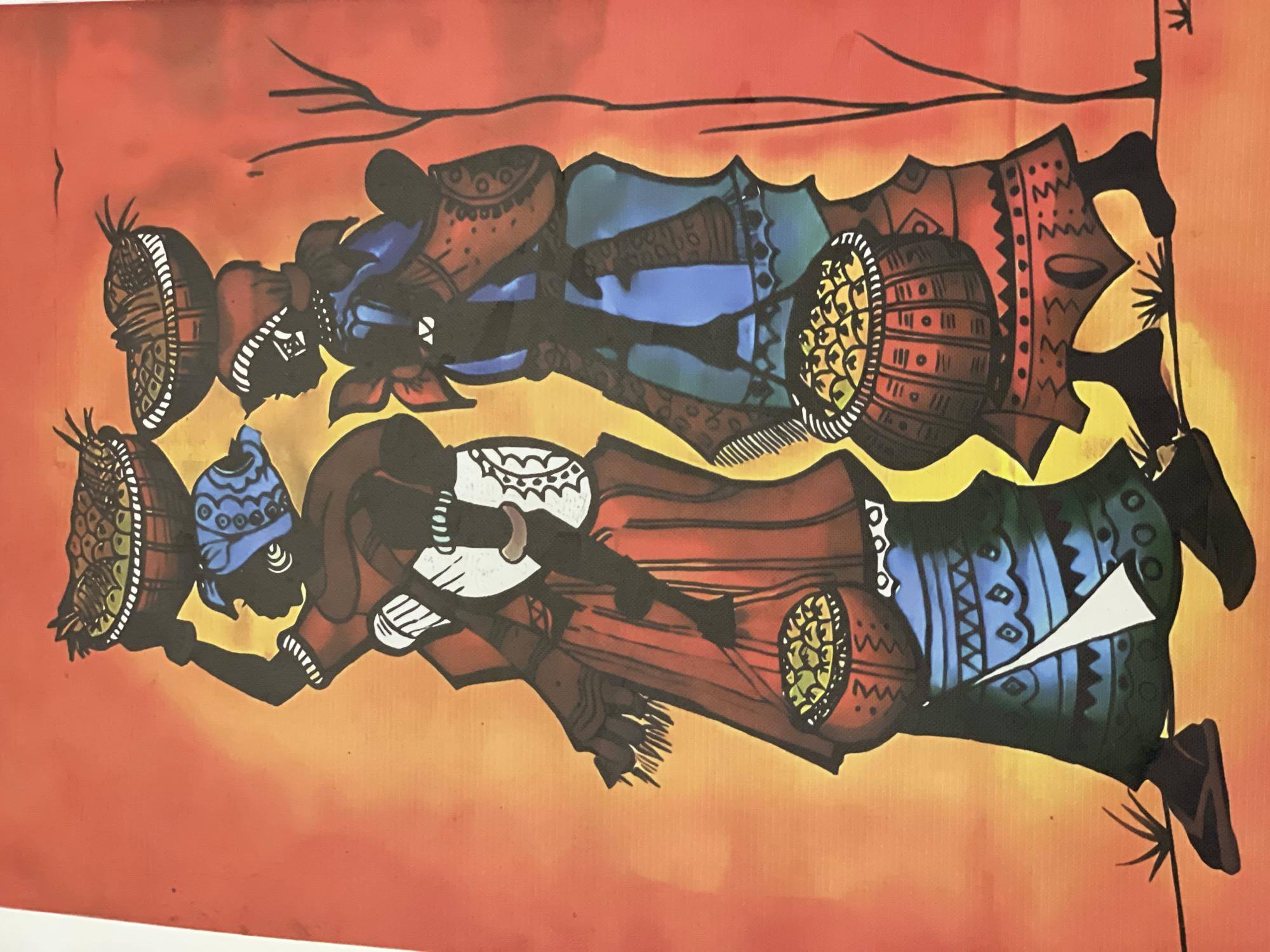 The image is a painting of two silhouettes of African women carrying baskets on their heads and in their hands. The woman on the left wears a blue headscarf and a red garment, with a baby strapped to her back. The woman on the right wears a red headscarf and a blue and green garment, also with a baby strapped to her back. Both women are depicted carrying woven baskets filled with what appears to be fruit. They are walking from left to right across a landscape with a gradient of orange and yellow. A thin, bare tree branch is visible on the right side of the painting. The style is reminiscent of traditional African art. The painting is a static, two-dimensional representation. The background is a vibrant, abstract wash of color.