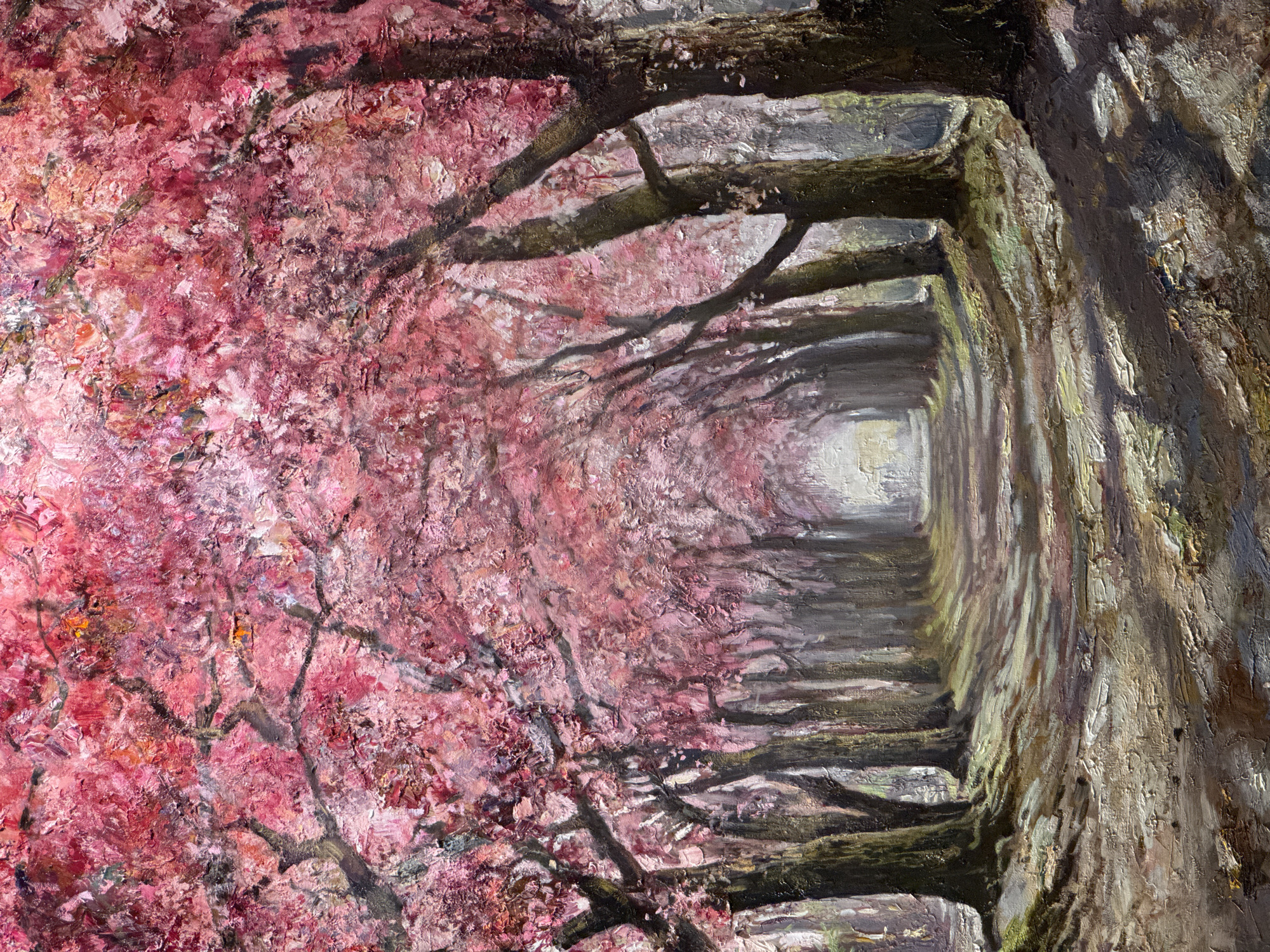 The image is an oil painting of a pathway lined with trees in full bloom with pink blossoms, creating a tunnel effect. The path is made of dirt and gravel, with dappled sunlight casting shadows from the trees. The trees on either side have thick trunks and dark branches heavily laden with vibrant pink flowers. The background recedes into a soft, misty light, suggesting a park or garden setting. There are no people or animals visible in the painting.
This scene is evocative of the alley of blossoming trees found in the Tauride Garden (Tavrichesky Sad) in Saint Petersburg, Russia. During spring, the garden is renowned for its spectacular display of flowering trees, including cherry and apple trees, which transform its pathways into picturesque, fragrant tunnels.