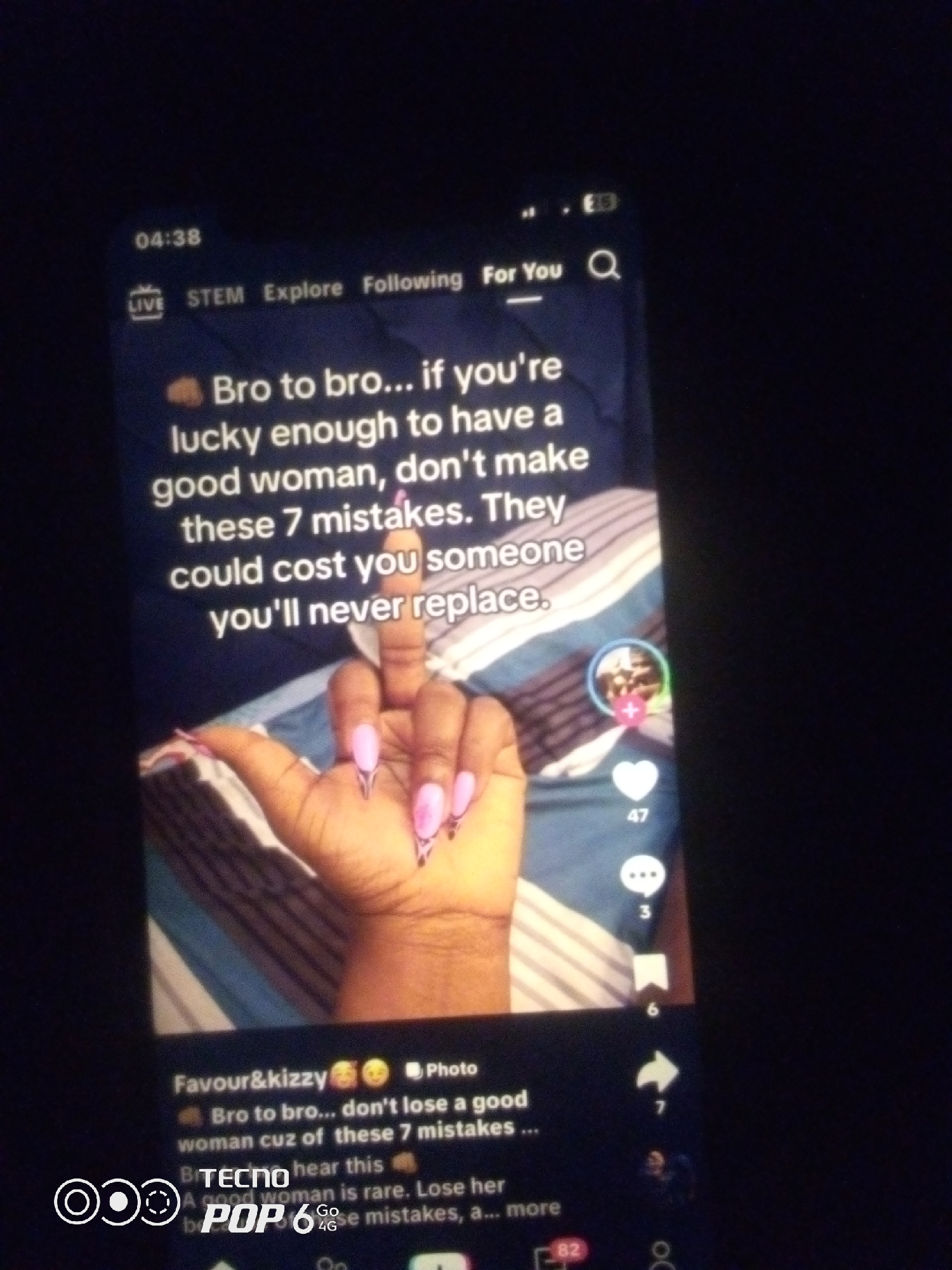 The image shows a close-up of a TikTok video playing on a smartphone. The video features text overlaid on a background of striped bedding. The text reads: "Bro to bro... if you're lucky enough to have a good woman, don't make these 7 mistakes. They could cost you someone you'll never replace." In the foreground, a hand with long, pink, acrylic nails is shown holding up a middle finger. Social media icons, including a heart with the number 47, a speech bubble with the number 3, and a bookmark with the number 6, are visible on the right side of the screen. The bottom of the screen shows the phone's brand, "TECNO POP 6," along with "Go 4G." The timestamp "04:38" is visible in the top left corner. The overall environment appears to be dark, suggesting the photo was taken in low light conditions. There is no information within the image to indicate the location in the city of Howayi, Nigeria.