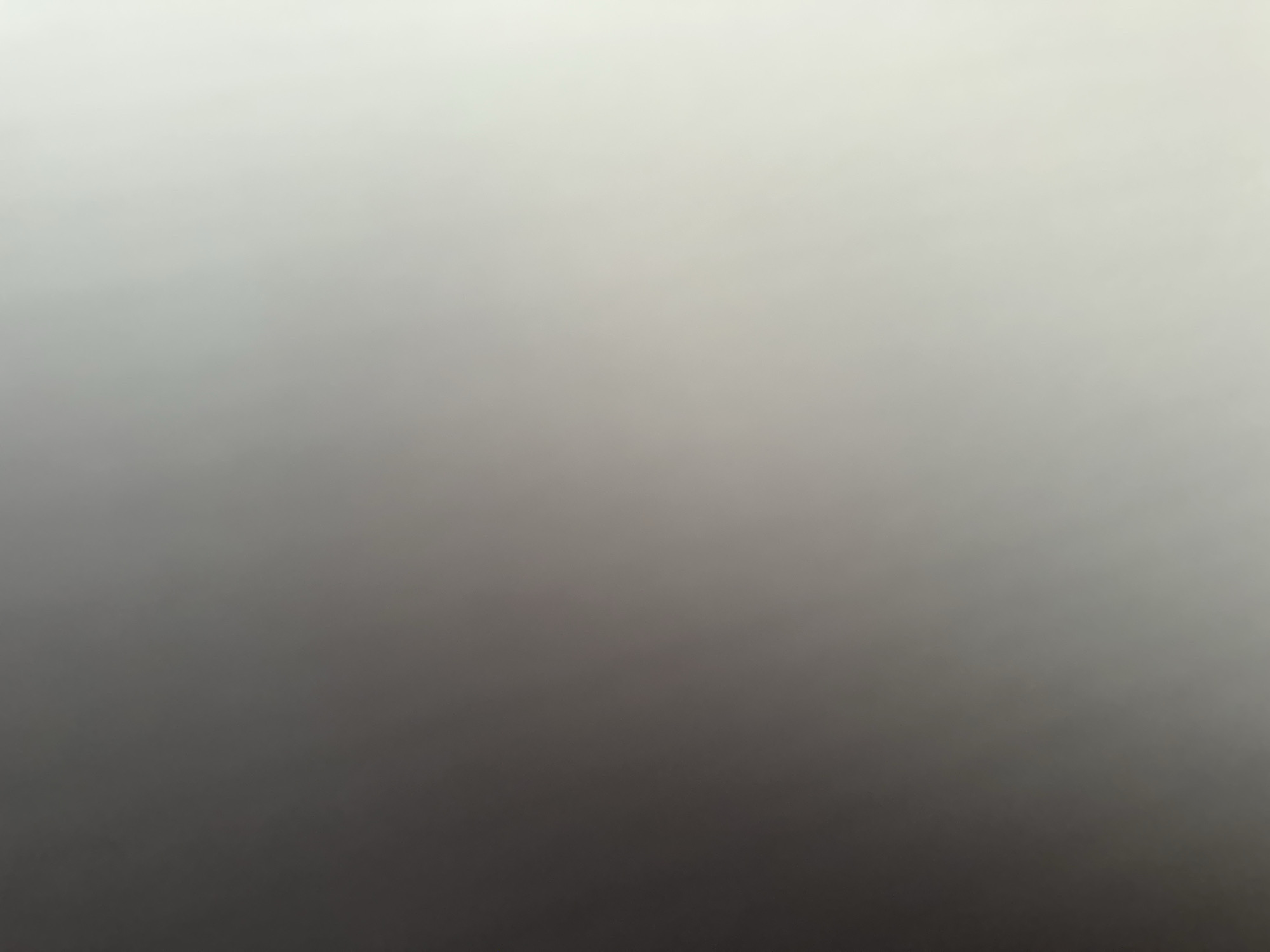 This image is a blurred, abstract gradient of grey and white, suggesting a soft focus or intentional blurring effect. It transitions from a darker grey on the left to a brighter white on the right. There are no discernible objects, people, or environmental features visible within the image. Therefore, it is impossible to provide details about its location in Belgrade, Serbia, or any specific scene.