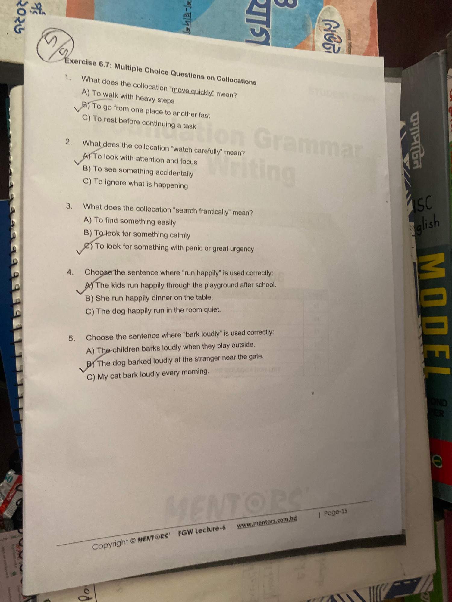 The image shows a page from an English worksheet titled "Exercise 6.7: Multiple Choice Questions on Collocations." There are five multiple-choice questions presented, each with three options (A, B, and C). Several questions have handwritten checkmarks next to specific options, indicating answers have been selected. For question 1, option B is checked. For question 2, option A is checked. For question 3, option C is checked. For question 4, option A is checked. For question 5, option B is checked. The bottom of the page displays "Copyright © MENTORS' FGW Lecture-8" and "www.mentors.com.bd | Page-15." The background shows books and papers, including a book with the title "ISC English" and a partially visible yellow book with the word "MODEL" printed vertically on its spine. The environment appears to be a domestic or educational setting. There are no people or interactions clearly visible in the image. The location of Hemayetpur, Bangladesh is not explicitly mentioned or deducible from the provided image.