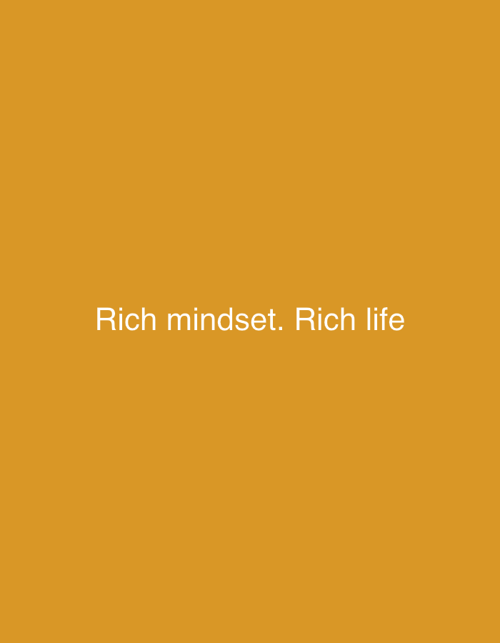 The image is a minimalist graphic featuring white text against a solid orange-yellow background. The text, centered on the screen, reads "Rich mindset. Rich life". The background is a uniform, untextured color resembling ochre or a deep marigold. No other objects, people, or activities are depicted in the image. There are no notable details regarding time of day, weather, or specific location cues; the setting is entirely abstract. The text is presented in a simple, sans-serif font.
