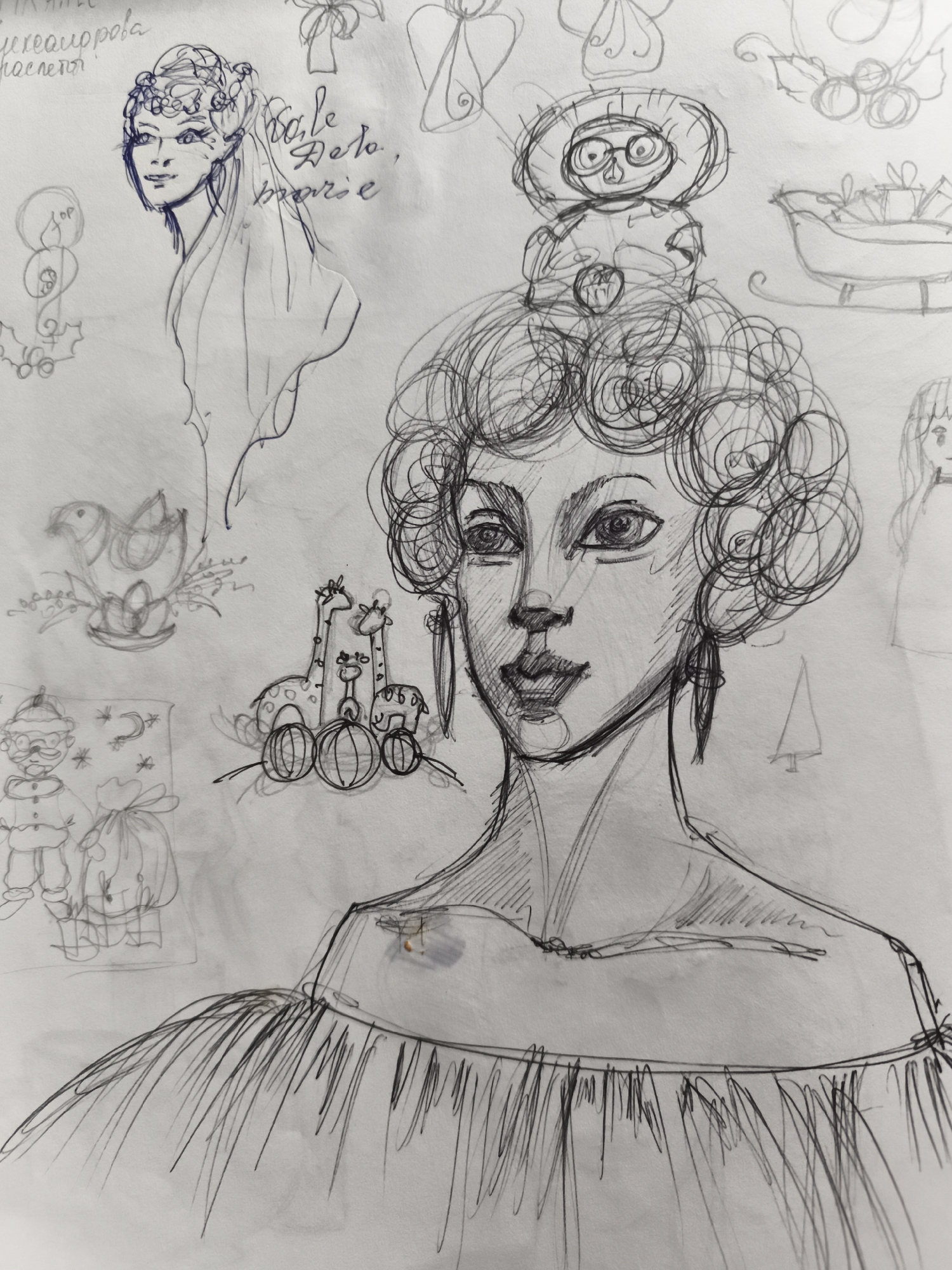 This is a pencil sketch on paper depicting various whimsical and festive drawings. In the center, a detailed sketch of a woman's face and upper torso is prominent, characterized by curly hair, large expressive eyes, and a flowing dress. To her left, a stylized sketch of a woman's head adorned with flowers and a veil is visible, with some handwritten text in Cyrillic script above it. Several smaller sketches are scattered around the main figure, including a sleigh with gifts, a robin perched on eggs, two giraffes with a sheep and balls, a figure resembling Santa Claus with a sack, and a small Christmas tree. There is no identifiable connection to Saint-Denis, France, in this artwork.