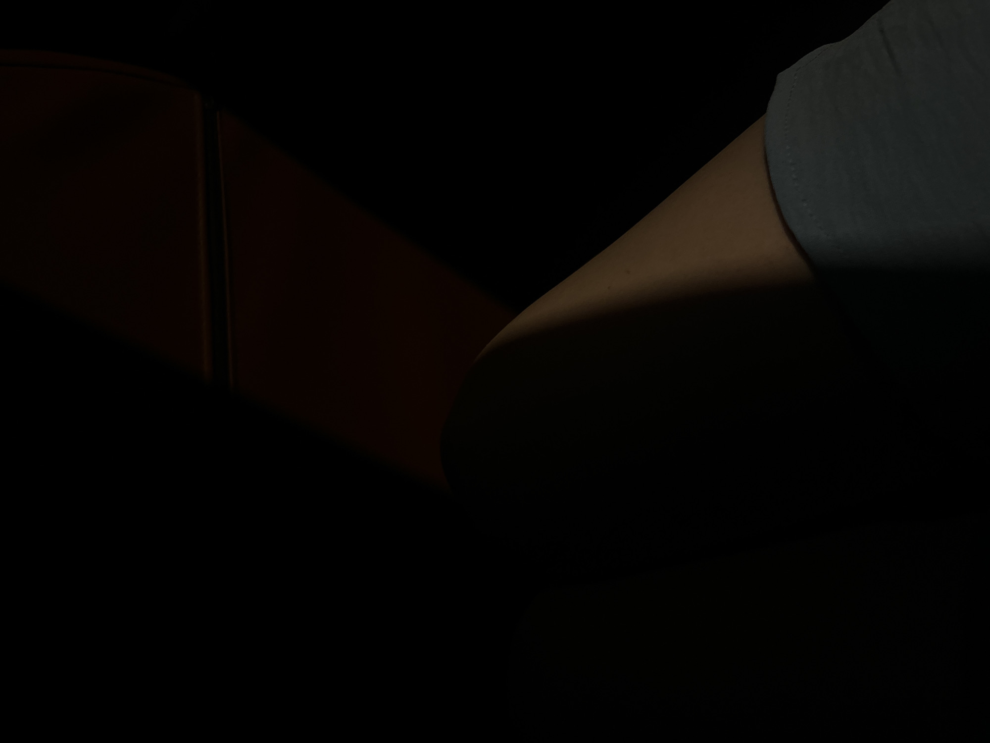 A person's arm is visible next to an orange surface under dark lighting conditions. There is no evidence in the photo to place the location in Moscow, Russia, or any other specific location.