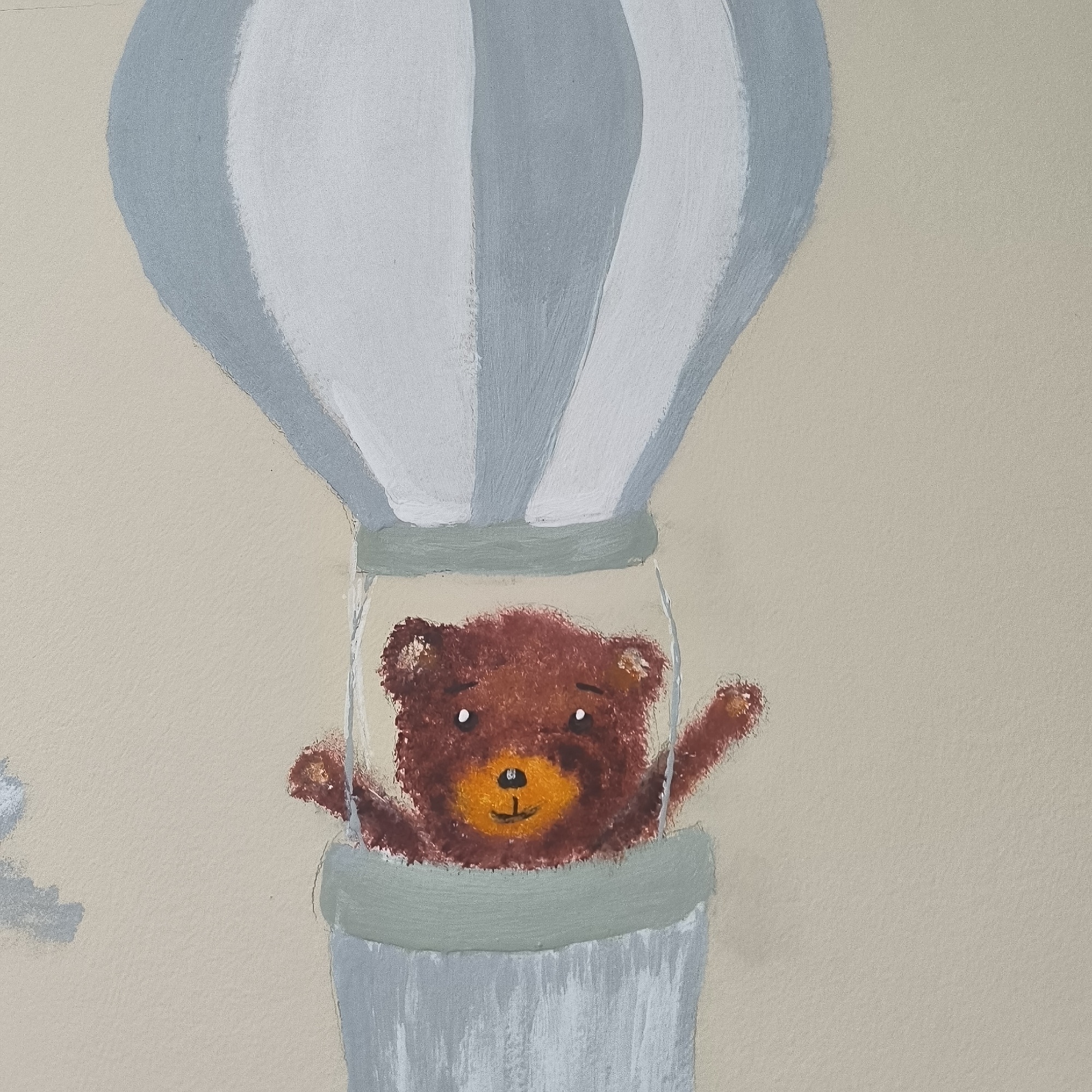 The image depicts a close-up of a mural painted on a textured wall, likely an interior wall of a building. The mural features a cartoonish brown teddy bear inside a basket of a hot air balloon. The hot air balloon is painted with alternating vertical stripes of white and light blue/grey. The basket is cylindrical with a light green rim and a light blue/grey lower section. The teddy bear has a round face, white eyes with black pupils, a small black nose, and an orange snout with a black smile. Its right arm is raised as if waving. The background is a solid, light beige color. There are no discernible landmarks or urban features visible that would indicate a specific location in Varna, Bulgaria, or any other city. The artwork appears to be a children's mural.