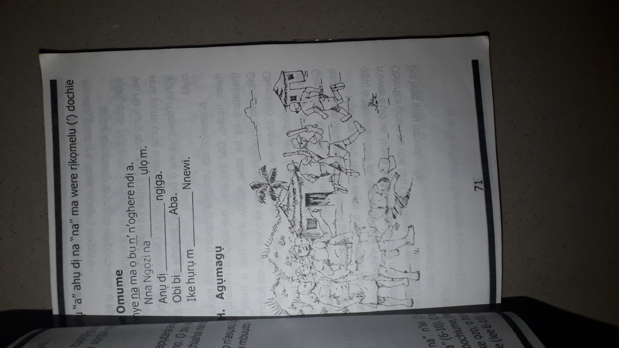 The image is a scanned page from a book, featuring text and an illustration. The text is in an unfamiliar language, likely an African dialect. The illustration depicts a group of people in a village setting. On the left, several men stand facing forward, some holding sticks. In the background, there are huts with thatched roofs. On the right, three figures, possibly boys, are running towards the huts, also holding sticks. A dog is lying on the ground in the middle of the scene. The page number "71" is visible at the bottom. The question asking for the location in Nkpor, Nigeria is a hallucination as there is no information in the image to support this.