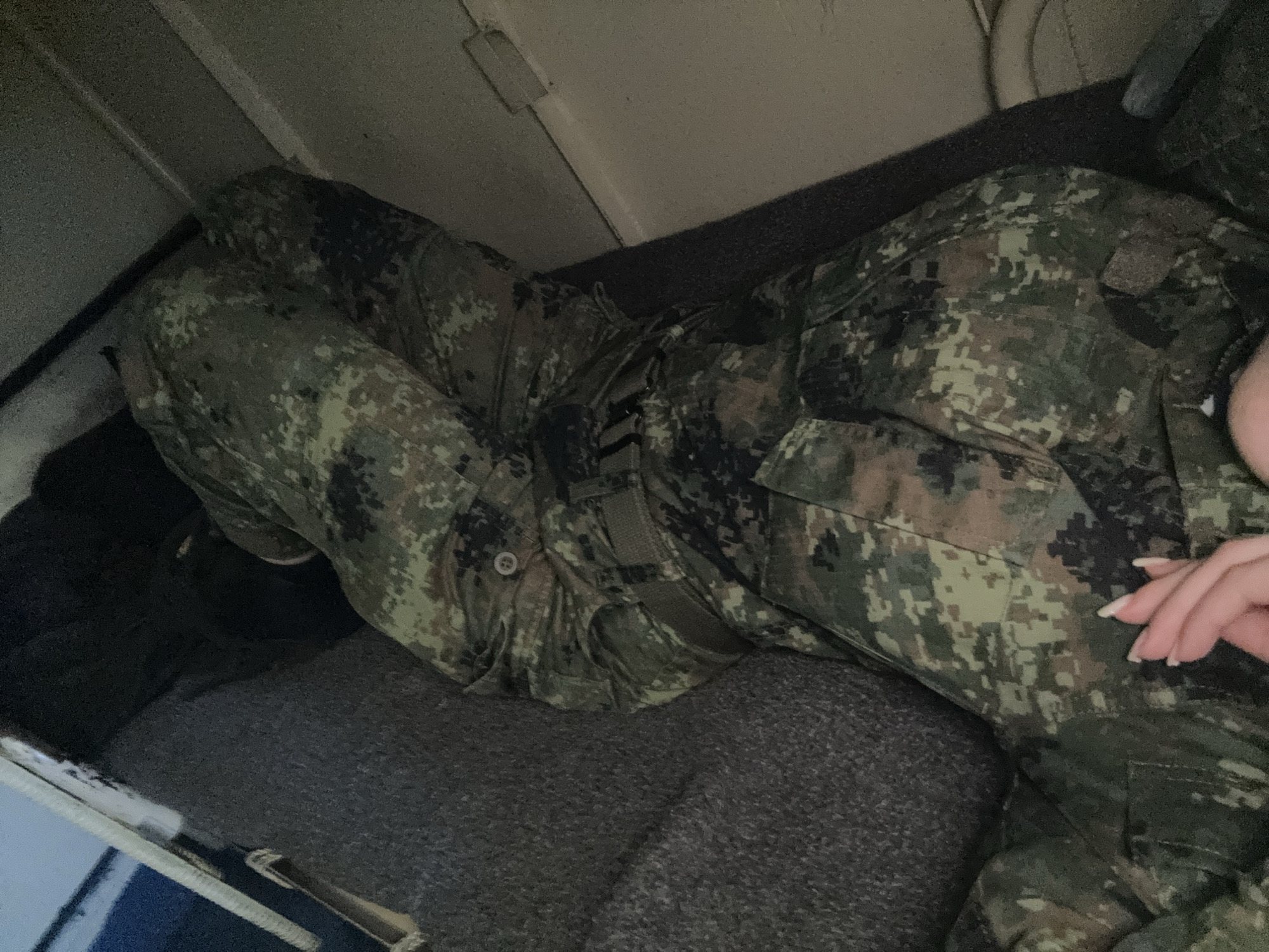 A person in camouflage uniform is lying down. The location cannot be determined to be Varna, Bulgaria, or any other specific location, from the provided image.