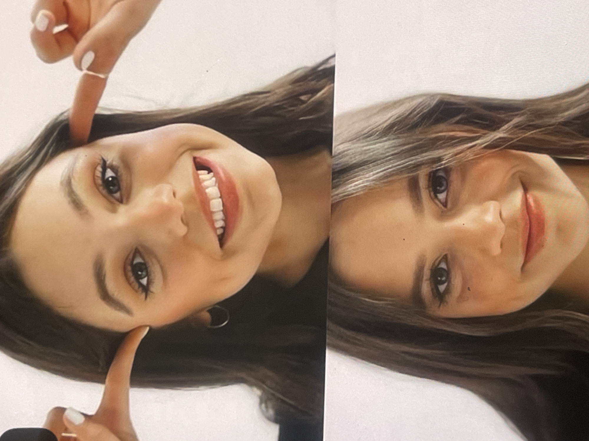 A diptych image features a young woman with long, dark hair, presented against a plain white background. The images are rotated, showing her head and shoulders from a tilted perspective.
In the left panel, the woman is smiling broadly, revealing her white teeth. Her index fingers are pointing towards her temples in a playful gesture. She has prominent eyeliner, dark eyebrows, and light-colored nail polish on her fingers, with a simple ring visible on one index finger. Her expression conveys joy and cheerfulness.
The right panel shows the same woman with a softer, more subtle smile. Her head is also tilted, and her long hair falls around her face. Her eye makeup is similar to the left panel. Her gaze is directed slightly away from the camera.
The overall impression is of a lighthearted portrait session. No text is visible in the image. The setting appears to be indoors, possibly a studio, given the neutral background. The location context for this media file is Poltava, Ukraine.