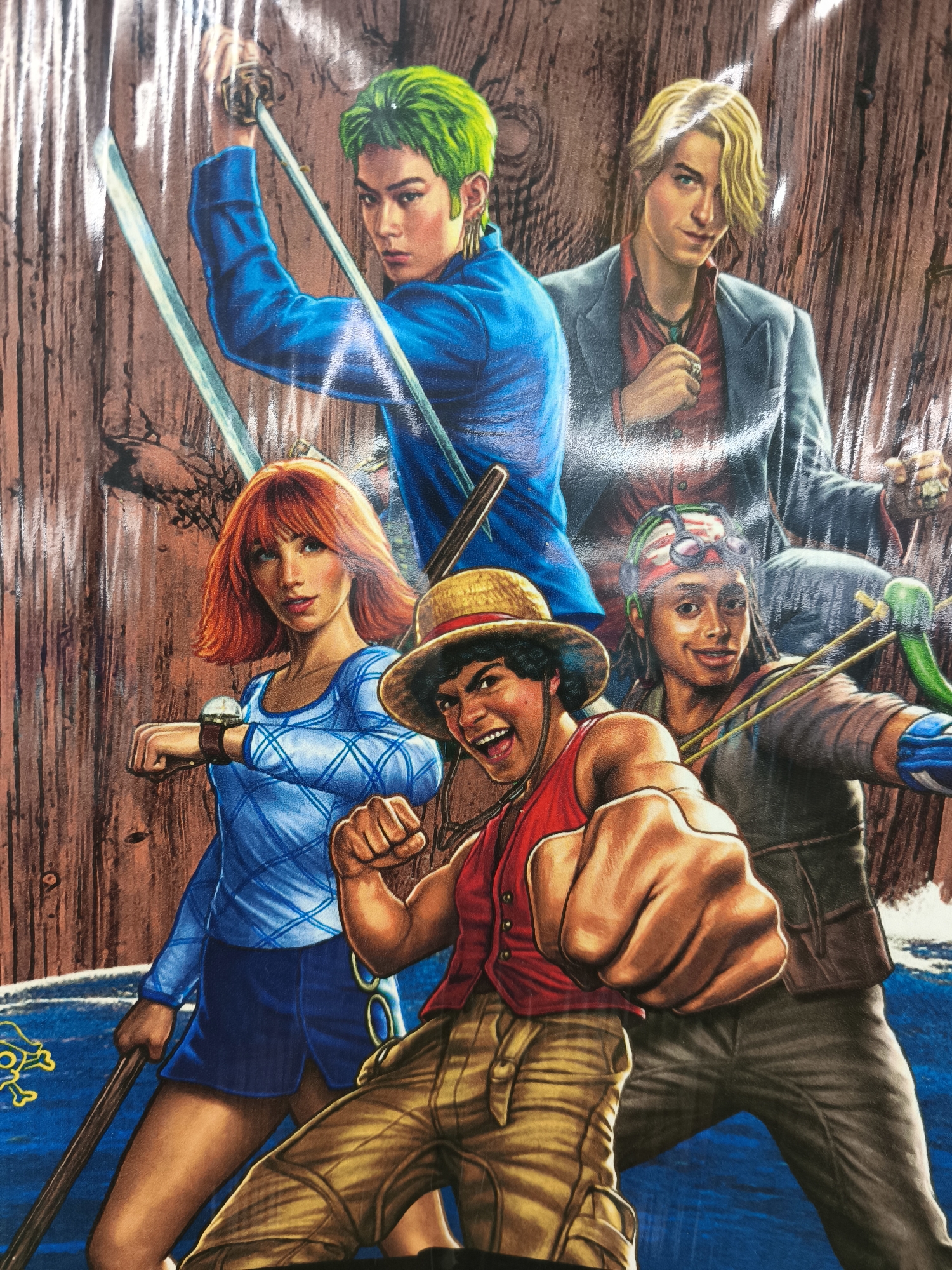 This is a close-up, eye-level shot of an illustration featuring a group of five young adults. They appear to be characters from an anime or manga, with distinct hairstyles and clothing.
In the background, a rustic, wooden wall provides a backdrop. In the foreground, a body of deep blue water is visible, with hints of a yellow Jolly Roger symbol on the left side. The overall impression is that of an adventurous scene, possibly at sea.
The characters are posed dynamically, suggesting action or preparation for a fight.
* On the far left, a person with bright green hair wields two swords, holding one aloft and another across their body. They wear a blue jacket.
* To their right, a fair-skinned individual with blond hair looks directly at the viewer with a confident expression. They are dressed in a red shirt, a dark blazer, and a necklace with a blue pendant.
* In the center, a woman with vibrant red hair and blue eyes looks forward, her expression neutral. She wears a light blue top with a diamond pattern and a dark blue skirt, and a large wristwatch on her left arm. She holds a dark wooden staff.
* In front of her, a person with dark curly hair and a bandana with goggles on their forehead is aiming what appears to be a slingshot. They wear a brown jacket and blue gloves.
* Dominating the foreground on the right is a person with a straw hat, a red vest, and tan pants. They are leaning forward and appear to be throwing a punch, their mouth open in an excited yell.
The lighting suggests daylight, and there are no immediate indicators of specific weather conditions. The stylized nature of the artwork and the characters' attire strongly suggest an anime or fantasy setting. No visible text is present in the image.