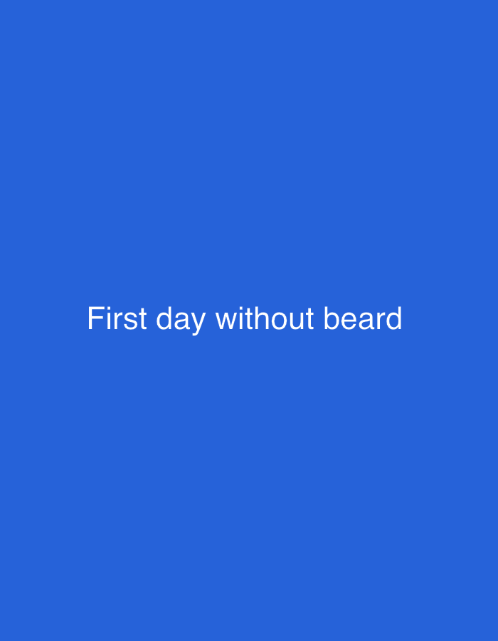 The image shows white text "First day without beard" centered on a blue background. No information is present to connect this image to the city of Blagoevgrad, Bulgaria or any other specific location. No people, subjects, objects, actions, interactions, or environmental details are depicted beyond the text and background.
