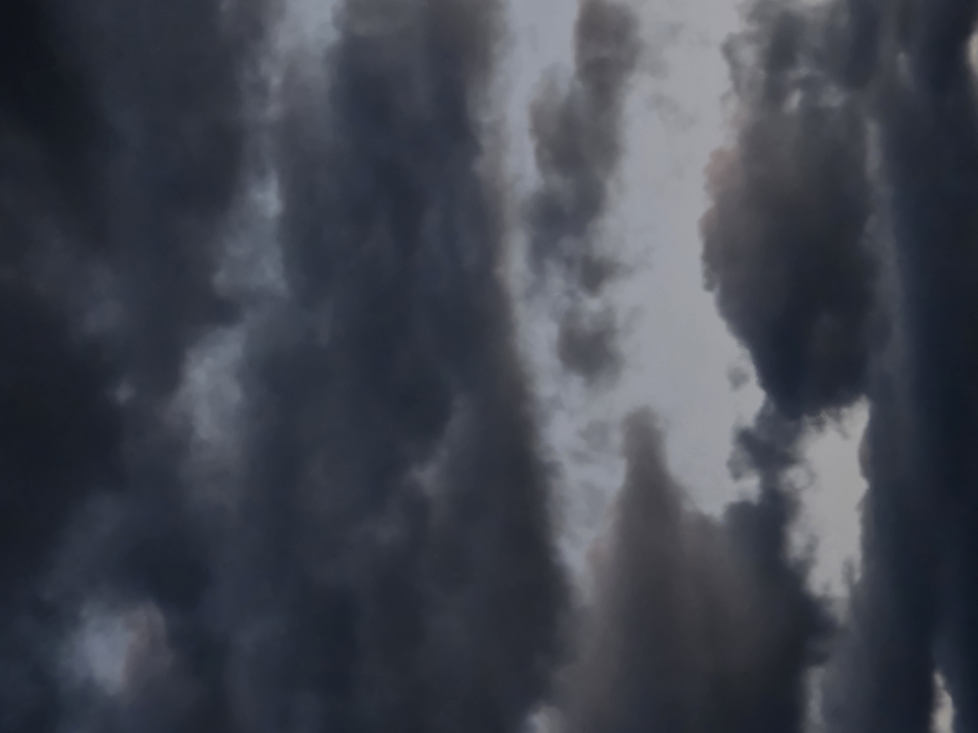 The image shows a sky filled with dark, heavy clouds. There are no discernable objects, people, or actions visible in this photograph. The scene is entirely dominated by the dramatic and overcast sky, suggesting a potentially stormy or dusk setting. The location within Magnitka, Russia, is not visually represented by any landmarks or context.
