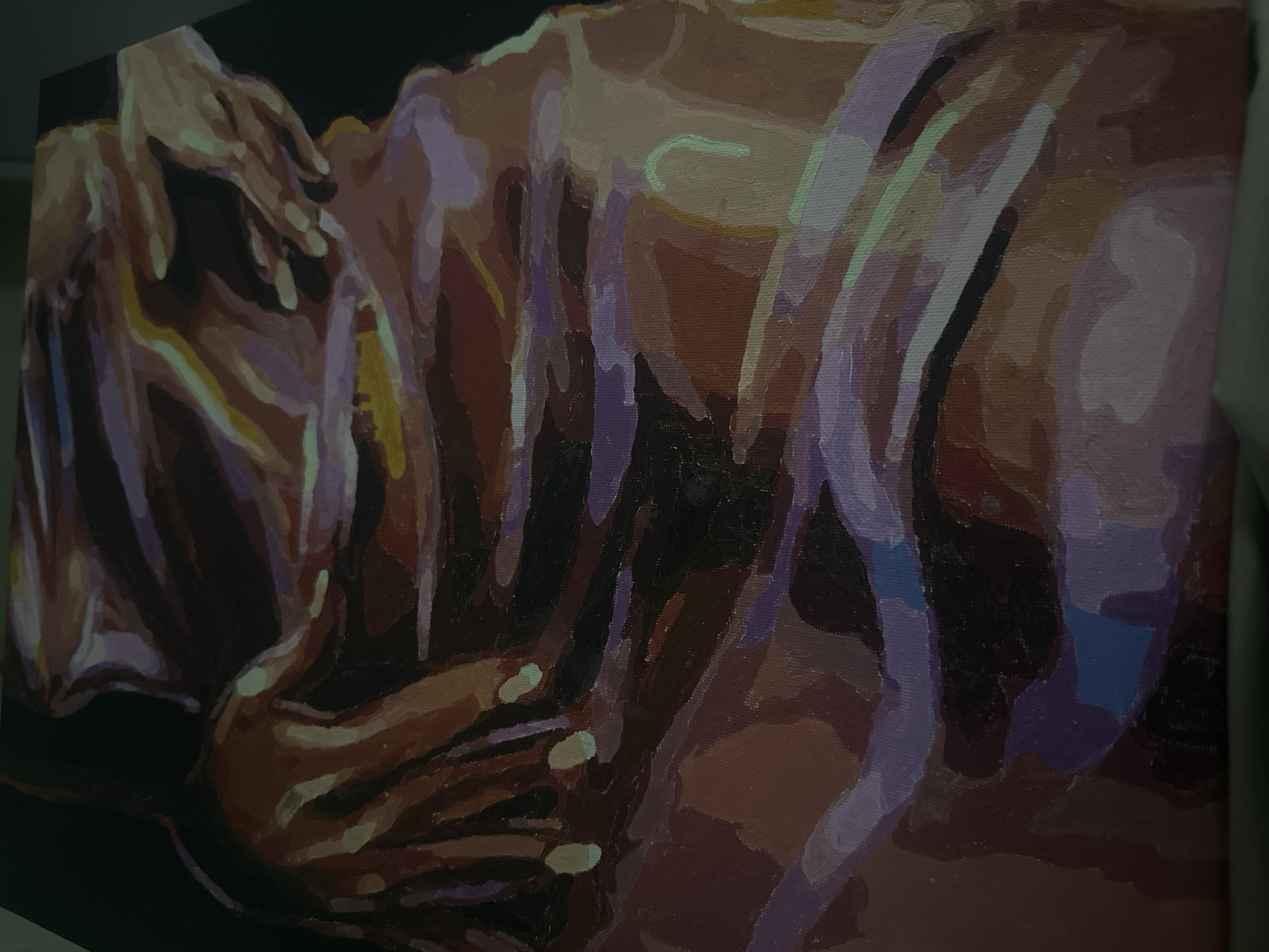 An oil painting on canvas depicts two or more human figures in an intimate embrace or intertwined pose, rendered in a semi-abstract style. The subjects are primarily torsos and hands. In the upper left, two hands are visible, appearing to rest on a shoulder or back. Another hand is visible in the lower center.
The artwork utilizes broad, distinct blocks of warm and cool colors, predominantly browns, purples, and oranges, with lighter highlights in cream, pale yellow, and hints of green and blue. The composition emphasizes the forms and contours of the bodies through strong, dramatic lighting, creating sharp contrasts between illuminated areas and deep shadows against a dark, likely black, background. The style uses non-blended, mosaic-like color patches to define muscles and curves. The texture of the canvas is visible in close-up crops, revealing the surface of the painting. No text is visible in the image. The overall impression is one of tenderness, passion, or close human connection.