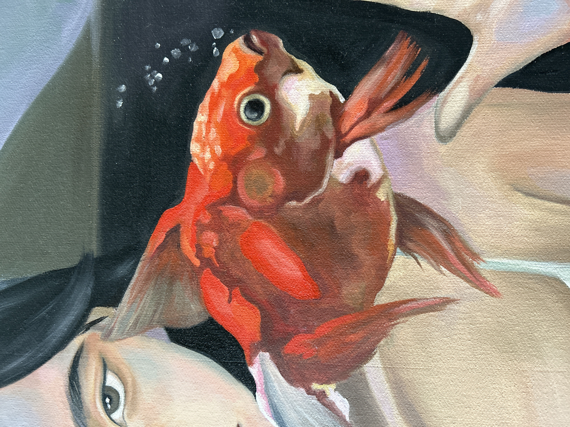 This is a close-up, artistically rendered painting. The central subject is a vibrant orange goldfish with white accents, depicted swimming in what appears to be water. To the left, a portion of a person's face is visible, featuring a brown eye with dark eyeliner and black hair framing the left side of the face. The person's skin is rendered with subtle pink and yellow tones. A hand, with light skin, is also visible on the right side of the frame, appearing to gently hold or interact with the fish. The background is dark, with a few small, scattered white circles that could represent bubbles. The painting style is realistic with visible brushstrokes, suggesting it is a piece of fine art. There is no information available to determine the location of this artwork in the city of Moscow, Russia.