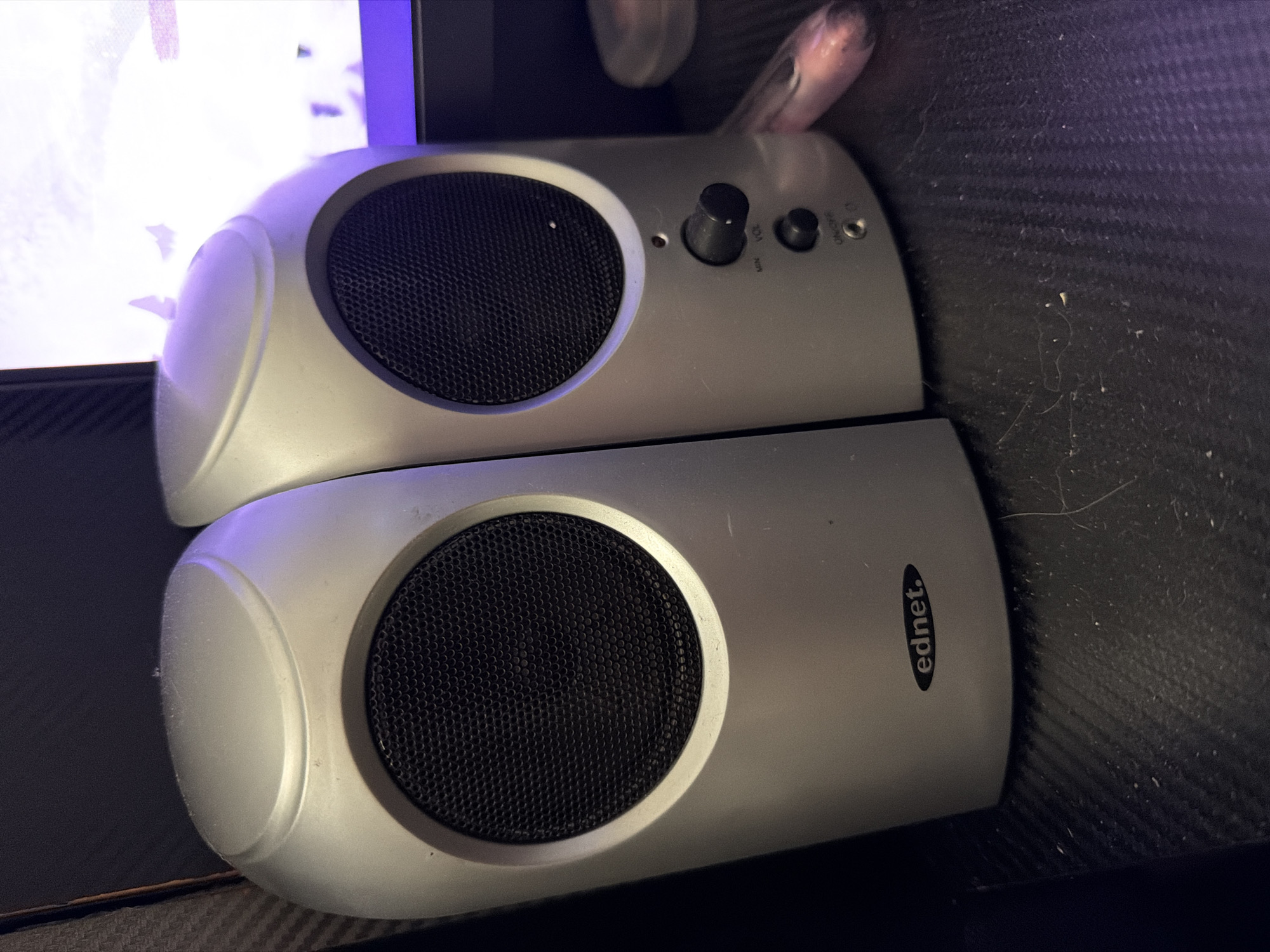 The image shows two silver ednet speakers stacked on top of each other. The top speaker has a volume knob and an on/off switch. The speakers have a round, mesh-covered opening. The image does not contain enough information to determine a specific location in Sofia, Bulgaria, or any information about people, actions, interactions, or details about the environment beyond the presence of the speakers.