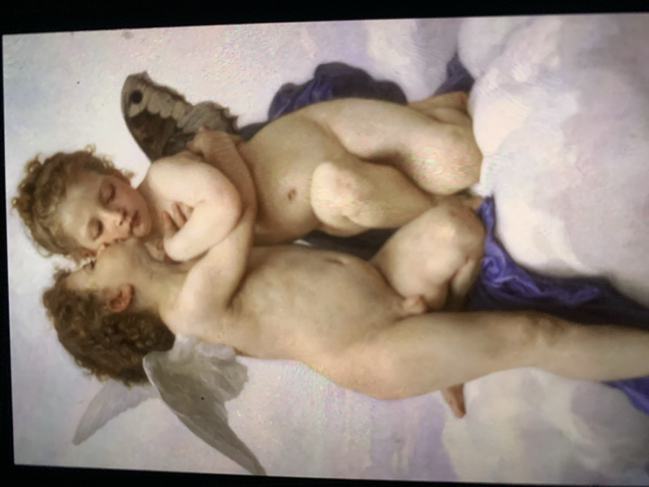 Two cherubic figures, rendered in a classical style, intertwine amidst clouds. The top figure, possibly female, embraces the lower one, their faces close. The lower figure, seemingly male, reclines with a singular wing visible. One cherub has butterfly-like wings. They lie on draped purple fabric near the clouds. The painting's light emphasizes the fleshy tones of the figures, conveying a sense of innocence and beauty.