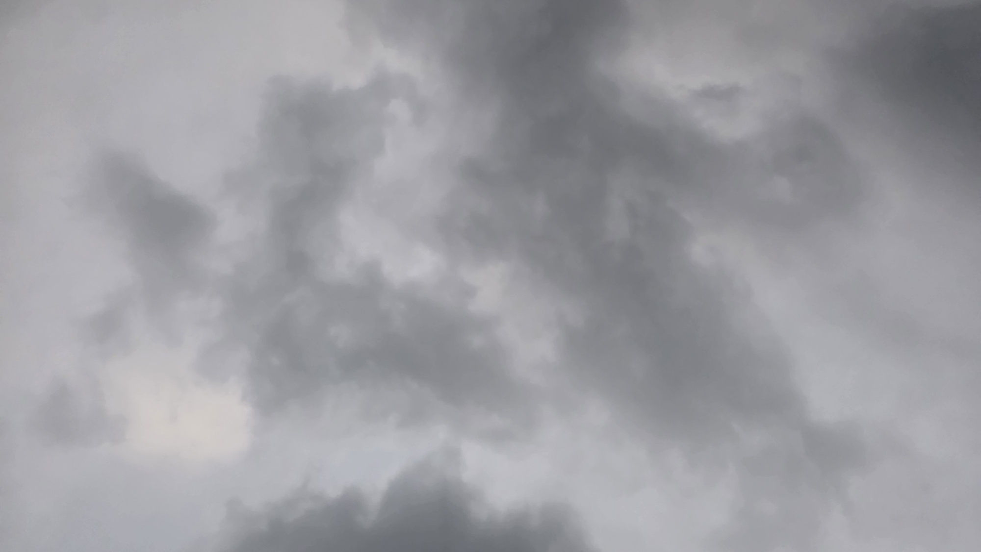 A cloudy sky is depicted, with dense, gray clouds filling the entire frame. The lighting suggests an overcast or impending stormy weather condition. There are no people, animals, or structures visible in the image, and no specific geographical markers are present to indicate the location in Chuy, Kyrgyzstan. The image focuses solely on the atmospheric conditions of the sky.