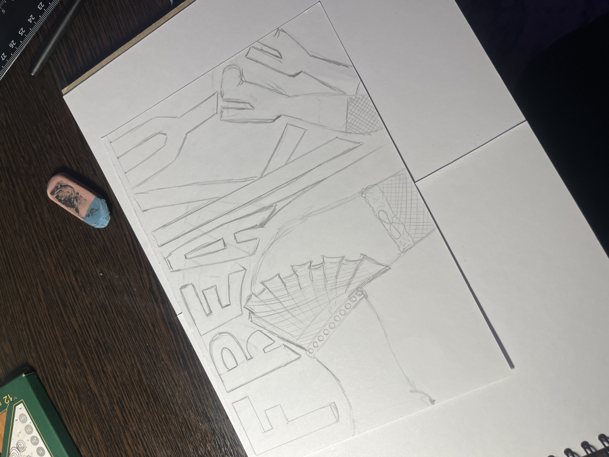 The image shows a pencil sketch on white paper resting on a dark wooden desk, with additional white paper sheets placed nearby. The drawing appears to be a complex design incorporating geometric shapes, lines, and what may be lettering. There is also a section of the drawing containing a fan and a patterned fabric section. Additional details include a pencil set and an eraser. There is no indication as to the location being Saint Petersburg, Russia in the image.