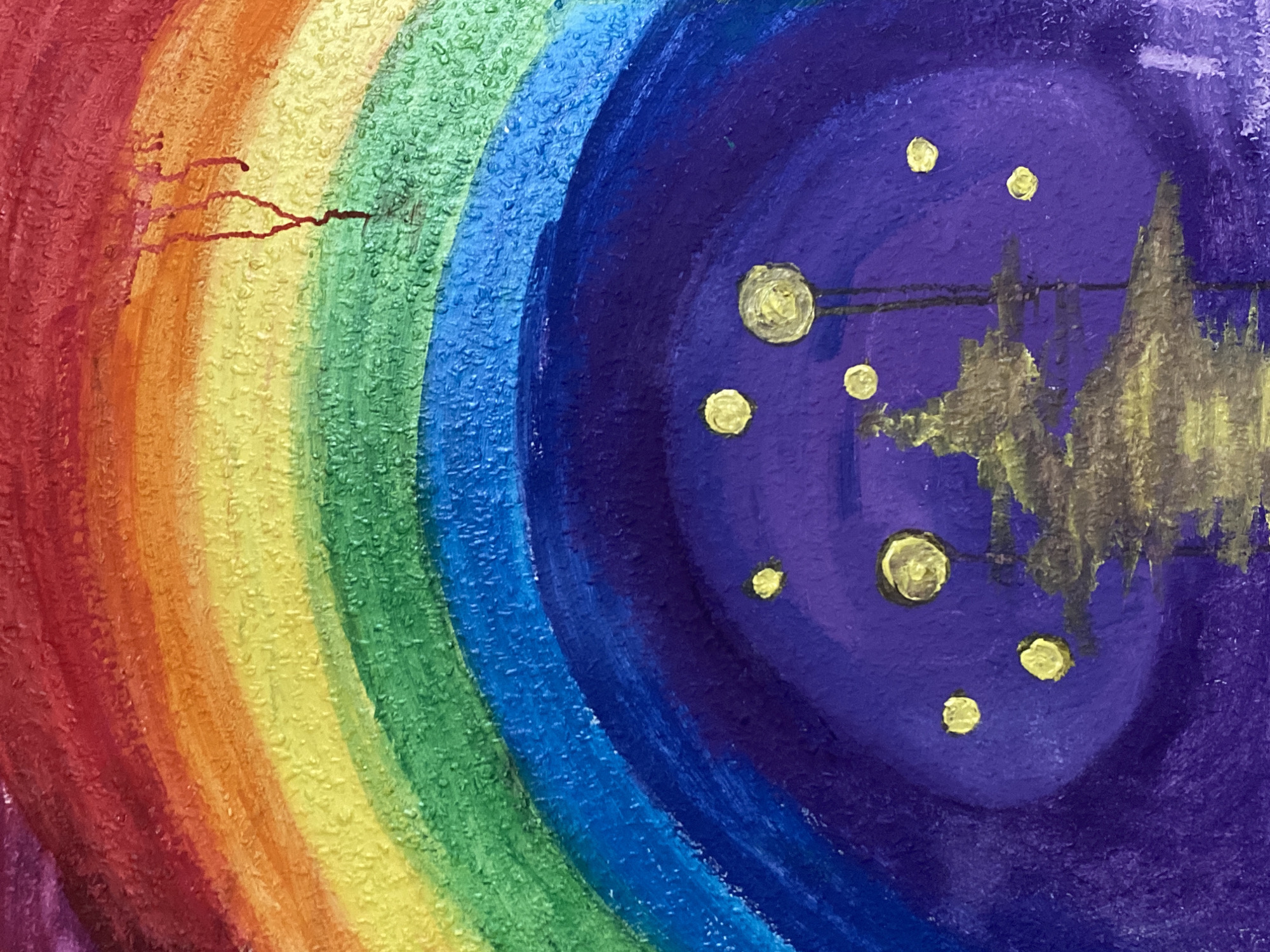 The image depicts a layered, circular painting with a rainbow on the left side gradually transitioning into a dark purple/blue night sky on the right. In the night sky, there are several irregularly shaped yellow blobs, likely representing stars. A jagged, ambiguous shape, possibly intended to depict buildings or a landscape, is also present in the night sky. The painting style is textured and appears to be acrylic or oil based. There is no indication in the image itself of any location in Chaikovsky, Russia.