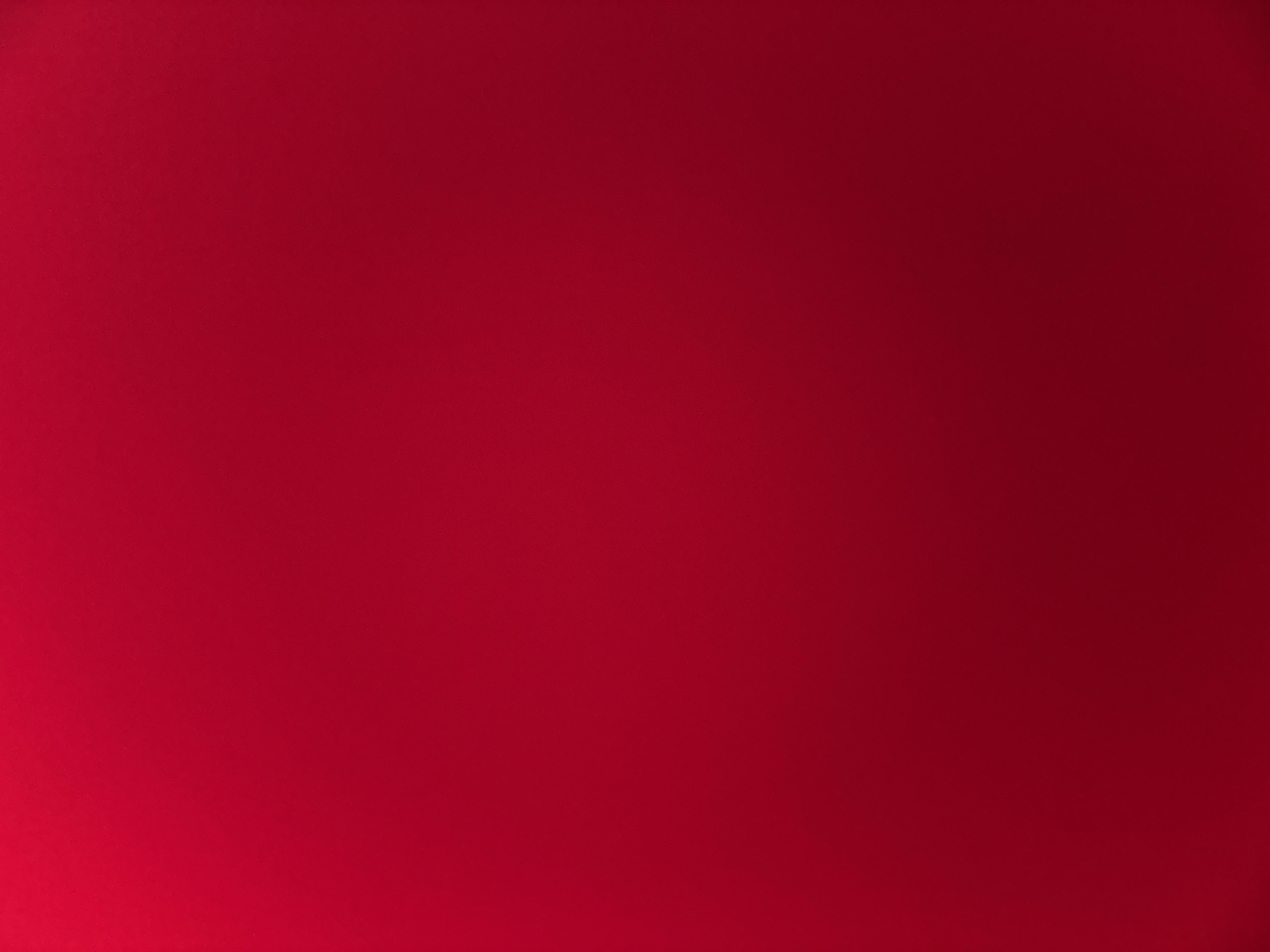 This media file is a plain, solid crimson background. There are no discernible subjects, objects, scenes, or settings. No activity or event is taking place. There are no notable details such as time of day, weather, location cues, or emotions. There is no visible text. The image is uniformly crimson with a slight gradient towards a darker shade on the right side.