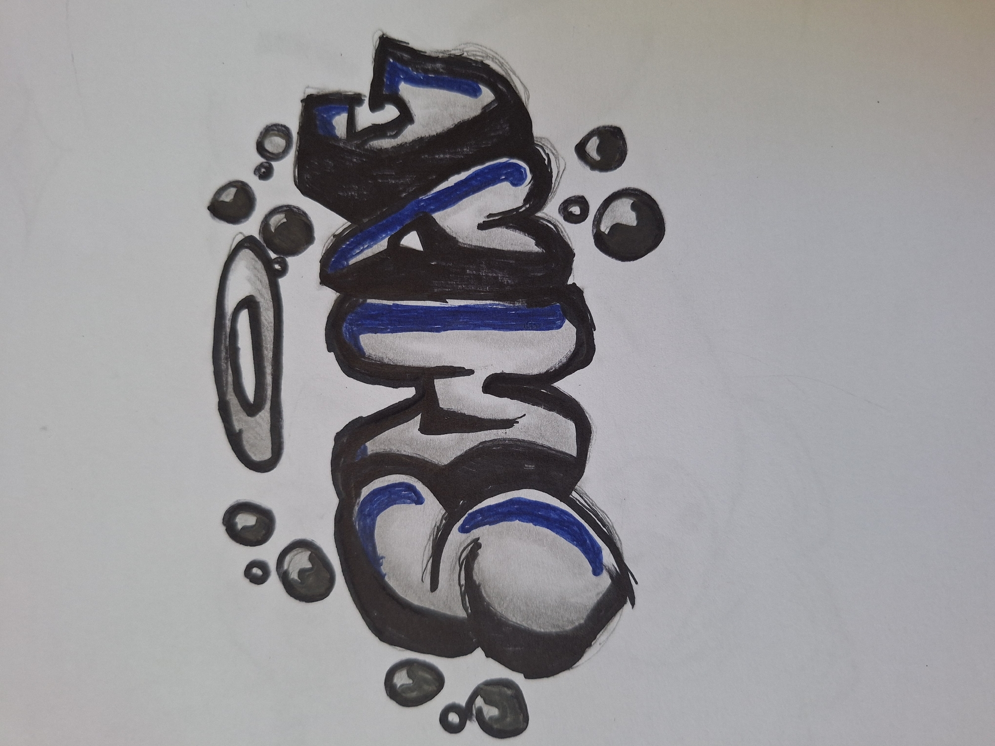 The image shows a drawing of the word "SHAX" in graffiti style, rendered in black and blue marker on a white surface. The letters are thick and rounded, with shading to give them a 3D effect. There are also several black circles and an oval shape drawn around the word, possibly representing bubbles or a halo. The drawing appears to be on paper, with some texture visible. The background is plain white, suggesting it is a sketch or a photograph of a drawing. The image is a close-up shot, focusing entirely on the artwork. There is no indication of the city of Varna, Bulgaria, or any other specific location in the image.