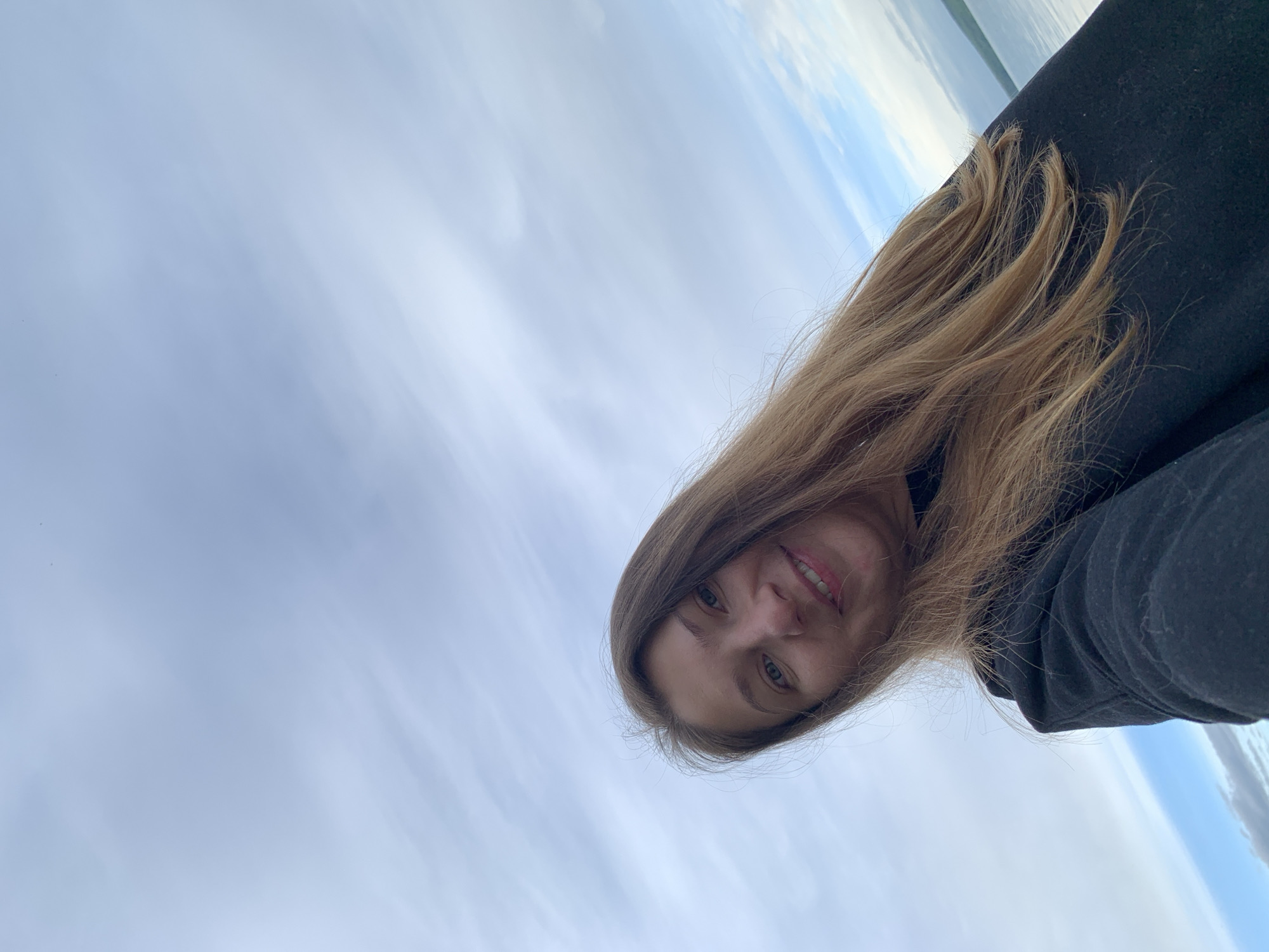 A woman is visible in the frame, positioned against a backdrop of sky. The photograph appears to have been taken with the camera tilted. The location is possibly Chaikovsky, Russia, though this cannot be definitively confirmed from the image.