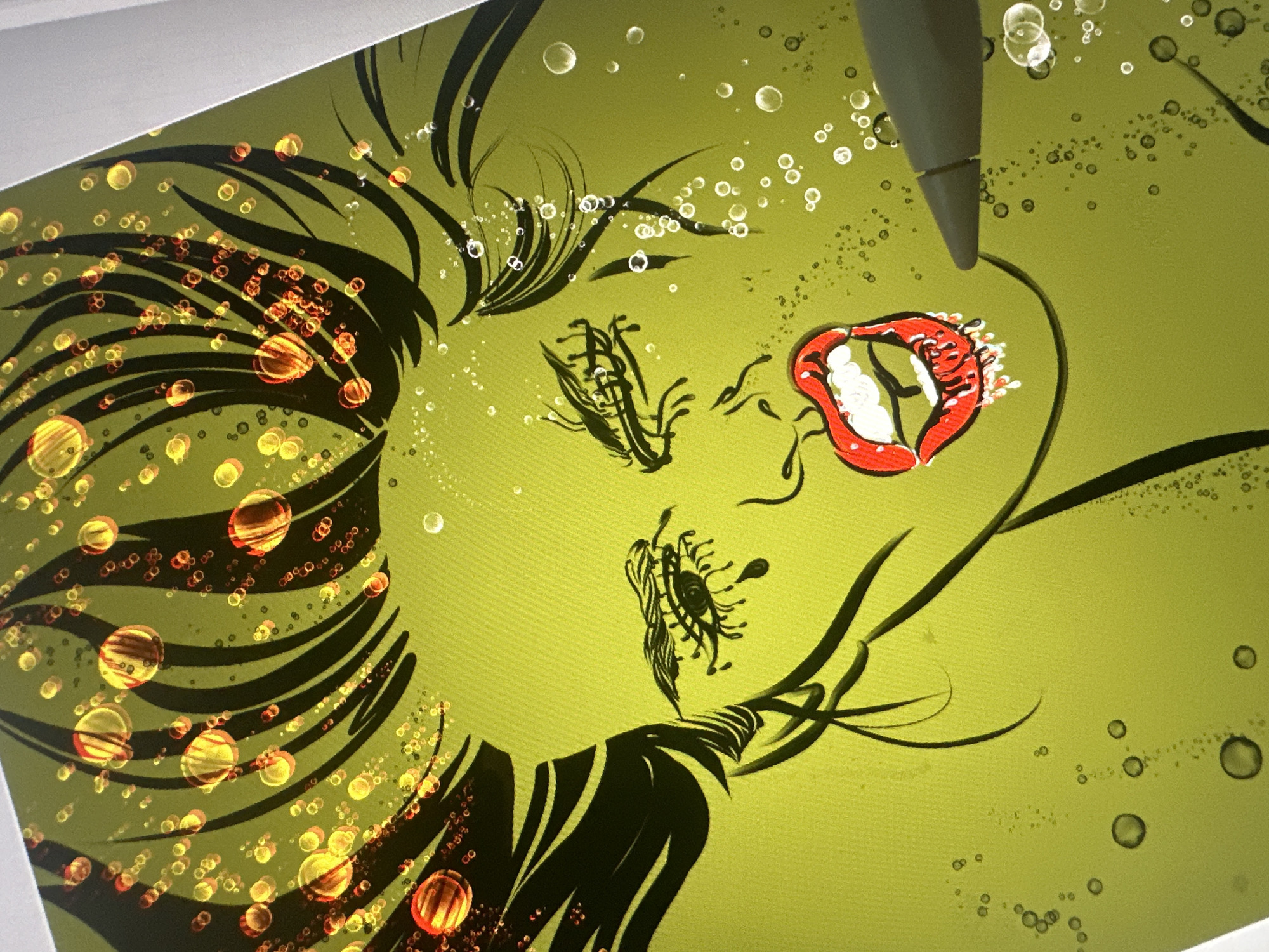 The image is a close-up, digitally created illustration of a woman's face rendered in a vibrant lime green color against a dark green background. Her eyes are closed with dramatic, spiky eyelashes. She has bright red lips, open and seemingly wet, with white highlights suggesting moisture or liquid dripping. Her dark hair is depicted as wild and spiky, with numerous red and yellow glowing orbs scattered throughout, giving the impression of bubbles or light refractions. Small white bubbles are also visible around her face and the foreground. A grey stylus is positioned on the right side of the image, close to the woman's mouth, indicating this is likely a digital artwork in progress. The overall style is graphic and illustrative, with bold lines and a stylized depiction of facial features.