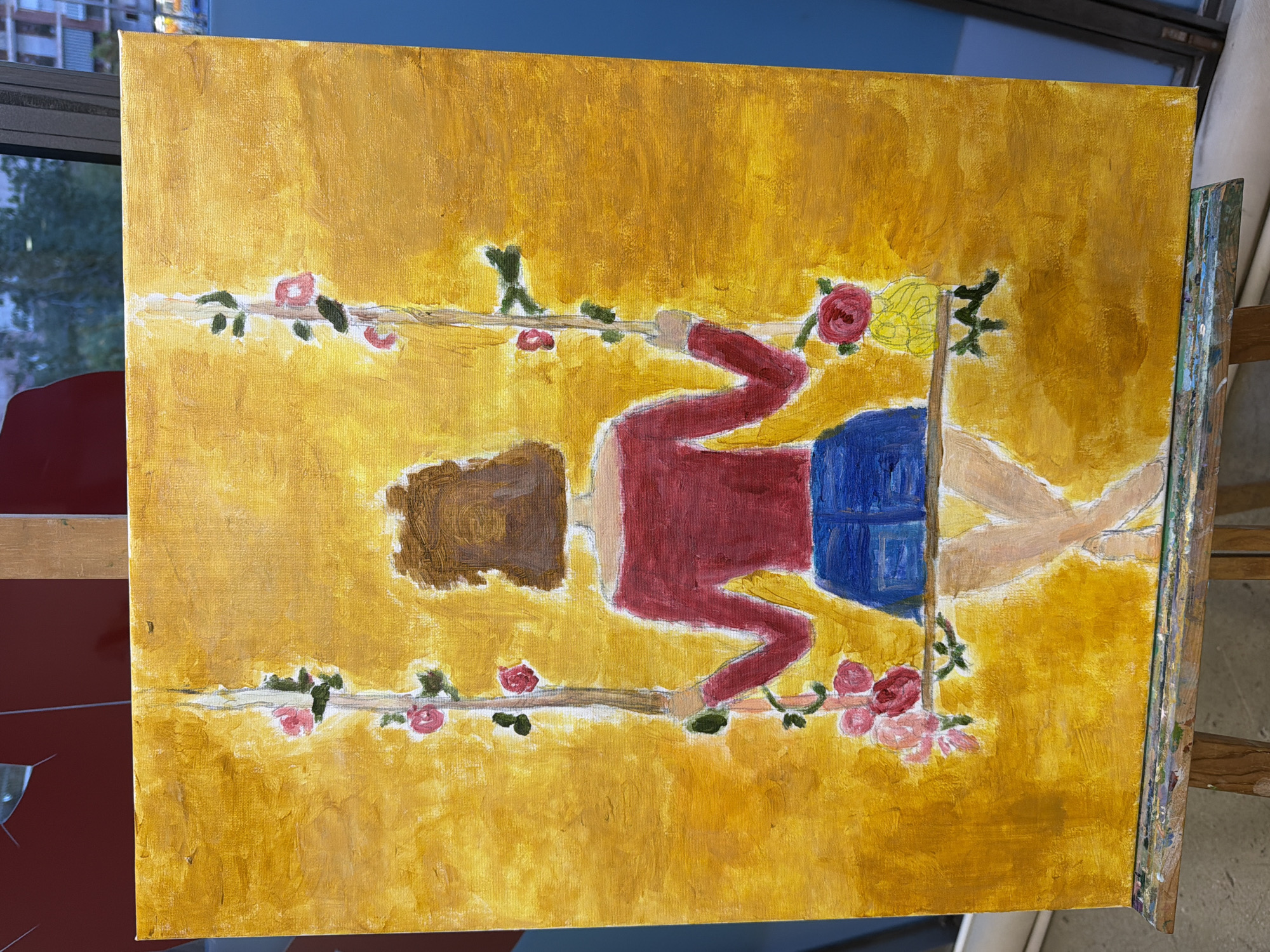 This is a painting of a person sitting on a swing. The person has brown hair and is wearing a red shirt and blue shorts. The swing is decorated with pink roses. The background is a bright yellow color. The painting is displayed on an easel.