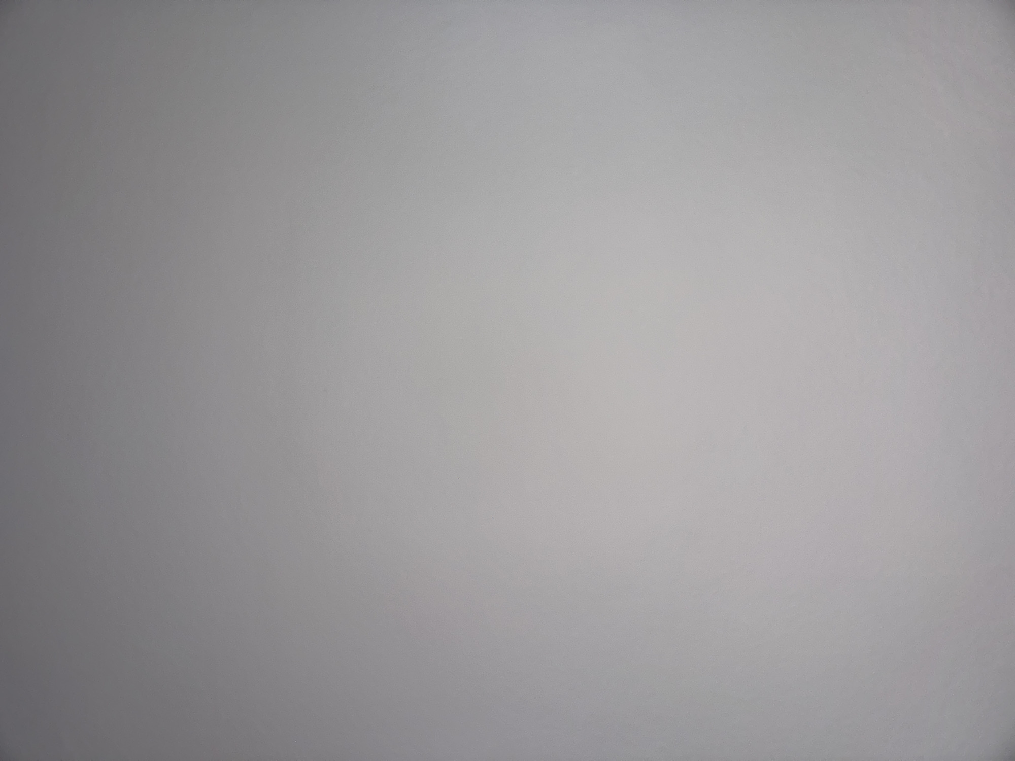 The image is a plain, solid gray surface with a slight variation in tone across the frame, indicative of uneven lighting. There are no discernible objects, people, actions, or contextual elements present that would allow for any determination of a location, including Topolovgrad, Bulgaria.