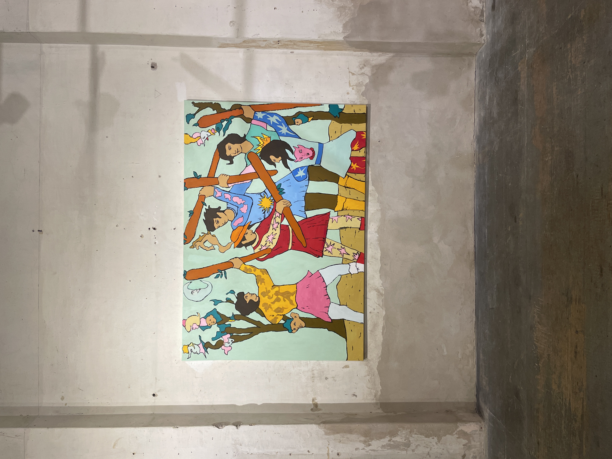 A painting hangs on a light-grey concrete wall. The painting is of figures holding tree branches. The figures are of different skin tones. The background of the painting is mint-green. The painting is in a corner of a building with grey concrete on one side and dark-brown wood on the other. The location is an interior. There is no information to confirm the city of Buenos Aires, Argentina.