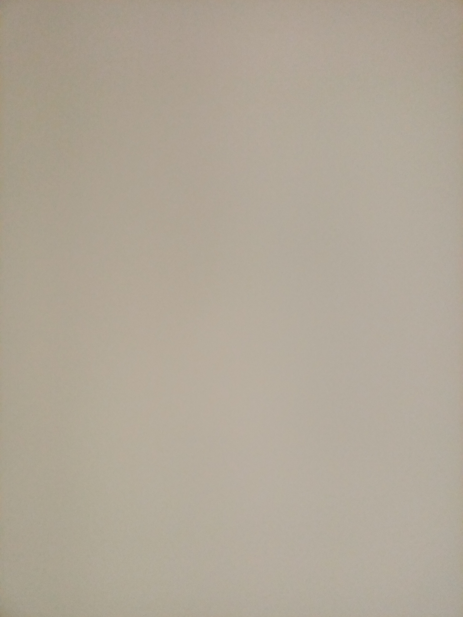 The image is a plain, light beige textured surface. There are no people, objects, or discernible features present. It is impossible to determine the location, city, or country from this image.
