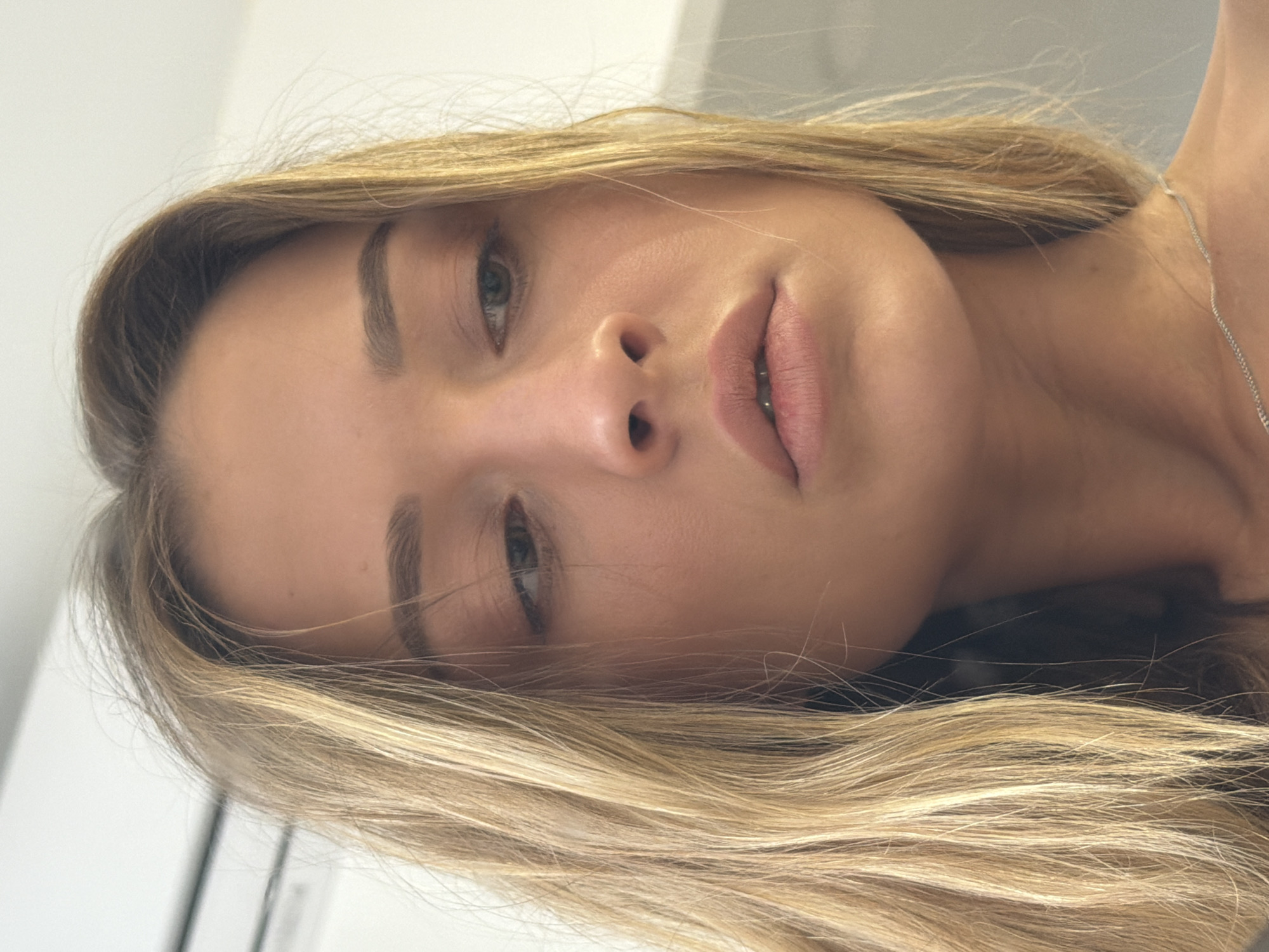 A close-up portrait of a fair-skinned woman with light blonde hair. She is wearing a silver necklace. The photograph appears to have been taken indoors. There is no indication of the image being located in Khimki, Russia, nor information on any actions, interactions or objects in the environment.