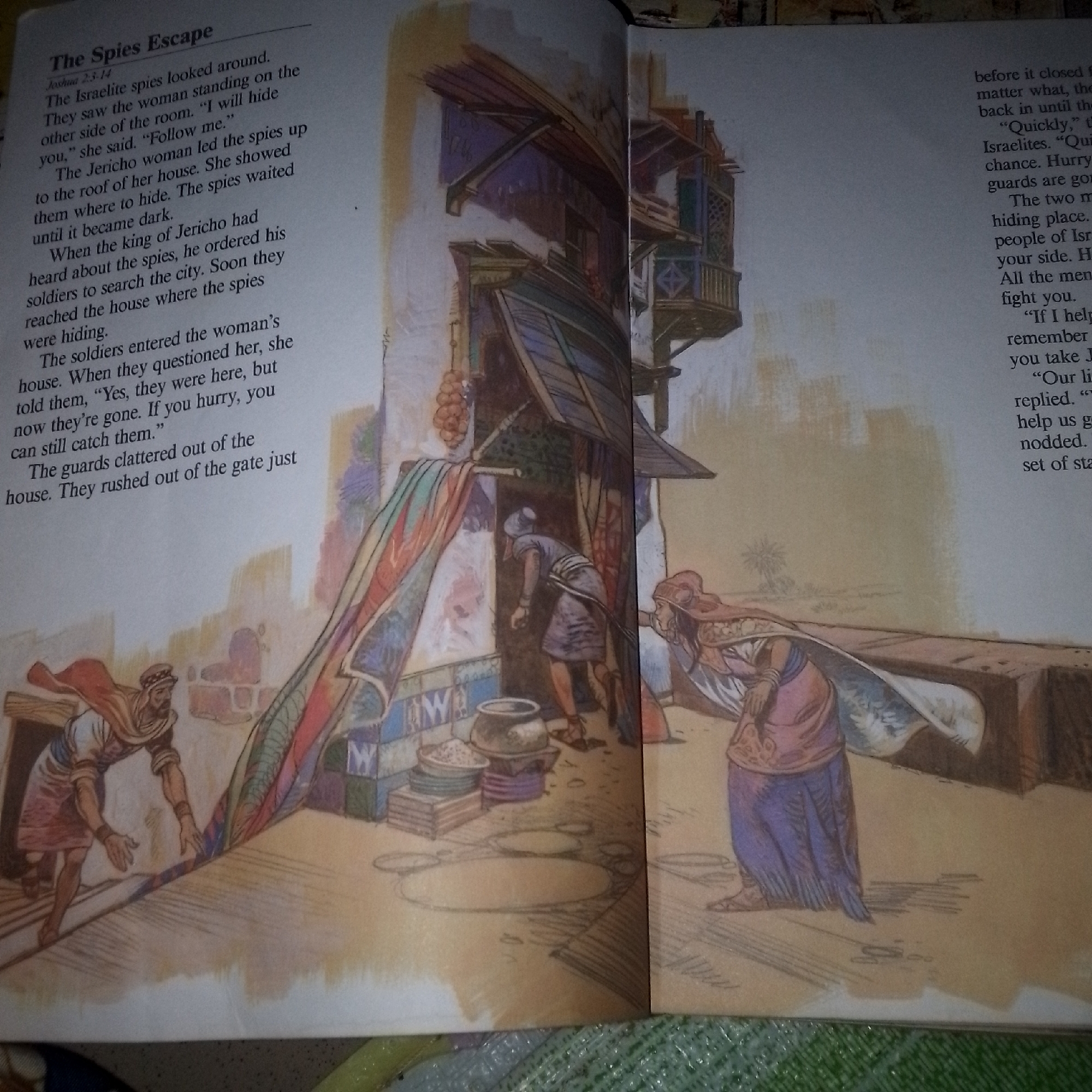 The image depicts a scene from a storybook, illustrating an event from the Bible, likely Joshua 2:1-14, titled "The Spies Escape." The illustration shows a multi-story building with an open doorway and several figures. On the left, a man wearing a red cape and head covering is pulling back a large, colorful textile. Inside the doorway, a person in a blue garment with a white head covering is bending over, appearing to be searching or looking for something. To the right of the doorway, another figure, possibly a woman, is walking away, wearing a pink garment and a blue skirt, with a large white and patterned cloth draped over her. The building itself has architectural details like wooden balconies and shutters. The ground is a textured surface with circular outlines. The overall setting appears to be an ancient urban environment. The question about Jalingo, Nigeria, is irrelevant to the content of the image.