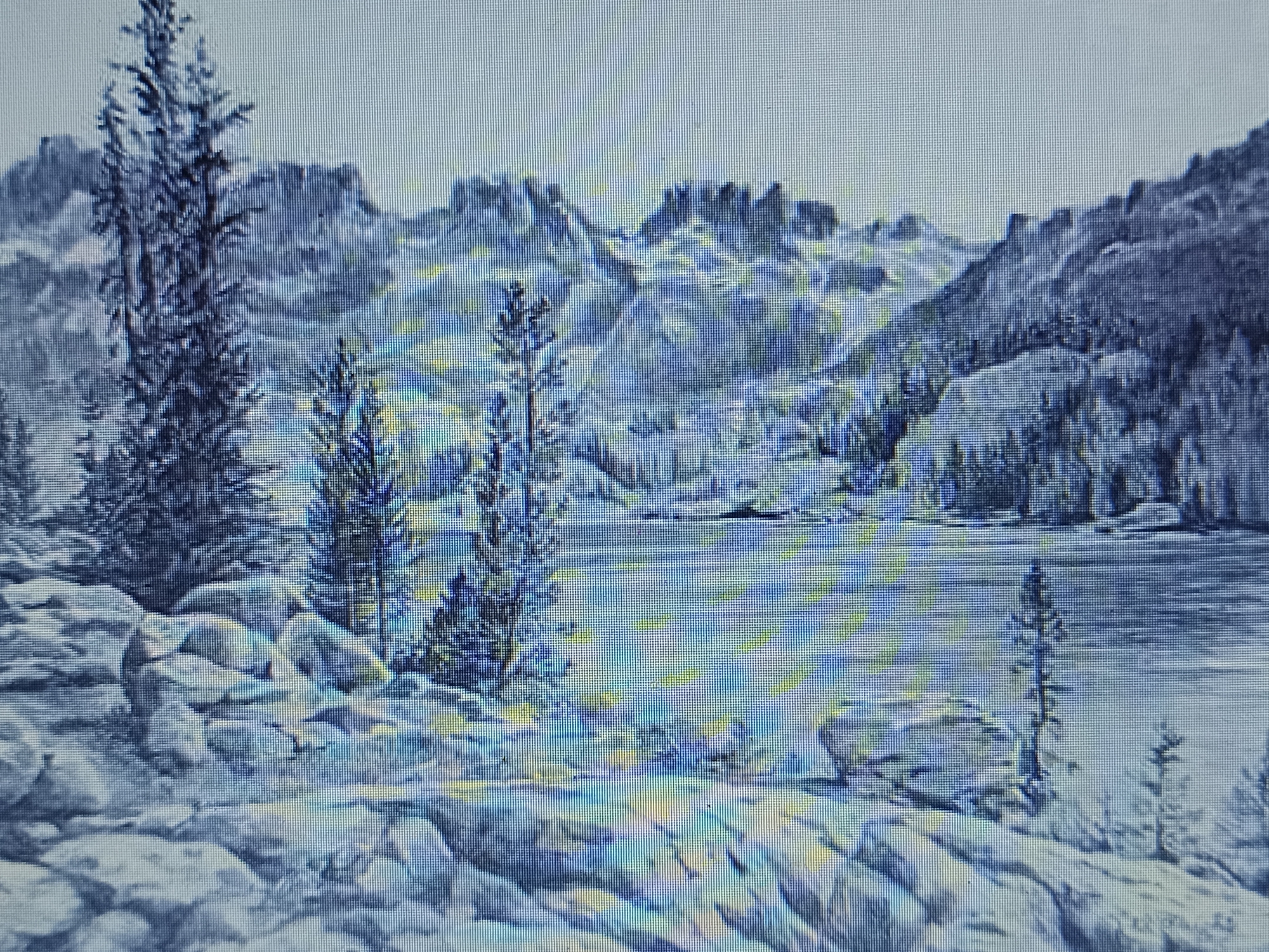 This is a digital rendering of a mountainous landscape with a lake. The scene is dominated by rugged peaks in the background, partially obscured by mist or low clouds. A dense forest of evergreen trees covers the slopes leading down to the lake. The foreground consists of large, scattered rocks, likely granite, some covered in what appears to be snow or frost. A few slender evergreen trees are present in the foreground as well. The lake itself is calm, reflecting the muted tones of the sky and mountains.
The overall impression is one of a cold, possibly early morning or late afternoon scene, given the diffused light. The weather appears to be cool, with a clear sky overhead. The style of the rendering, with its distinct pixelation, suggests it is a digital image, perhaps from a screen or a low-resolution scan. There is no text visible in the image, and no people or specific objects are depicted, focusing solely on the natural scenery. The location context of Košice, Slovakia, provides a general geographical reference but no specific visual cues within the image itself point to this location. The mood is serene and perhaps a little somber due to the cool color palette and the starkness of the mountainous terrain.