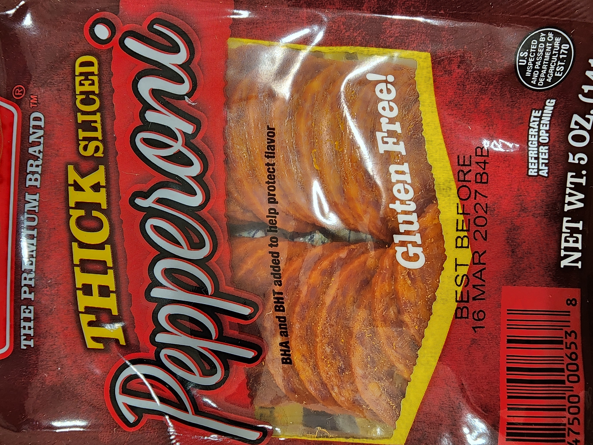 A package of "Thick Sliced Pepperoni" is displayed. The packaging is primarily red with yellow and white lettering. The pepperoni slices are visible through a clear plastic window. Text on the packaging includes "THE PREMIUM BRAND," "THICK SLICED PEPPERONI," "BHA and BHT added to help protect flavor," "Gluten Free!," "BEST BEFORE 16 MAR 2027 B4B," "NET WT. 5 OZ. (141g)," and "U.S. INSPECTED AND PASSED BY DEPARTMENT OF AGRICULTURE EST. 170." A barcode is also present. The image is a close-up of the product packaging, with no environmental context beyond the product itself.