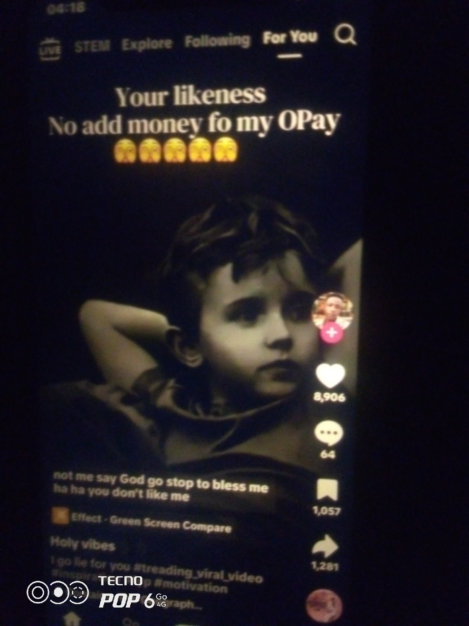 The image is a screenshot of a TikTok video. The video features a young boy with his arms behind his head. Text overlays on the video read "Your likeness No add money fo my OPay" with multiple shocked emojis below. Further text at the bottom includes hashtags like #motivation and #treading_viral_video. The overall impression is that of a typical social media video with accompanying engagement metrics like likes, comments, shares, and saves displayed on the right side of the screen. The image is dark and blurry, indicating it was likely taken in low light conditions or a low-quality camera. There is no information within the image that indicates a specific location in Howayi, Nigeria.