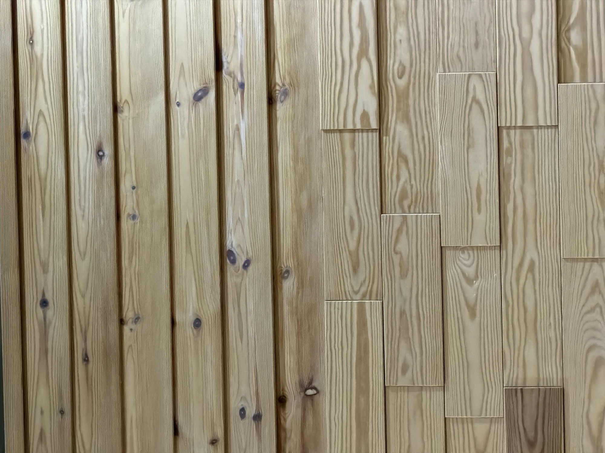 The image shows a wooden wall paneling with two distinct patterns. The left half of the image features vertical wooden planks with knots. The right half displays a staggered pattern with shorter wooden planks of similar material and grain. There is no indication of location or time. There are no people, interactions, or actions evident.