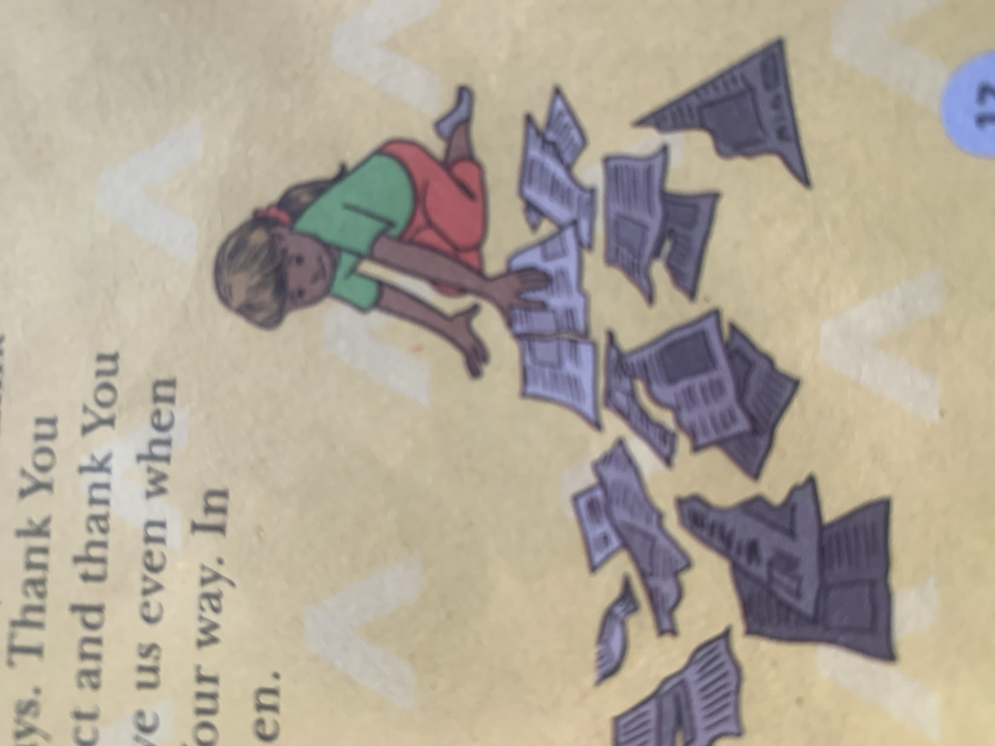 The image depicts a close-up of a page from a book, likely a children's book, with text and an illustration. The text, partially visible at the top left, appears to be a prayer or a thank you message. The illustration features a young girl with brown hair tied back with a red ribbon, wearing a green shirt and red pants. She is kneeling on a textured, yellow background and is actively sorting through a pile of what appear to be crumpled pieces of paper, possibly newspapers or drawings. The scattered papers are dark gray or purple and are depicted in various states of disarray around the girl. The overall impression is of a child engaged in an activity involving paper. The provided crops offer closer views of the text and the girl's interaction with the papers. There is no information or visual context within the image to suggest a location in Jauro Yinu, Nigeria.