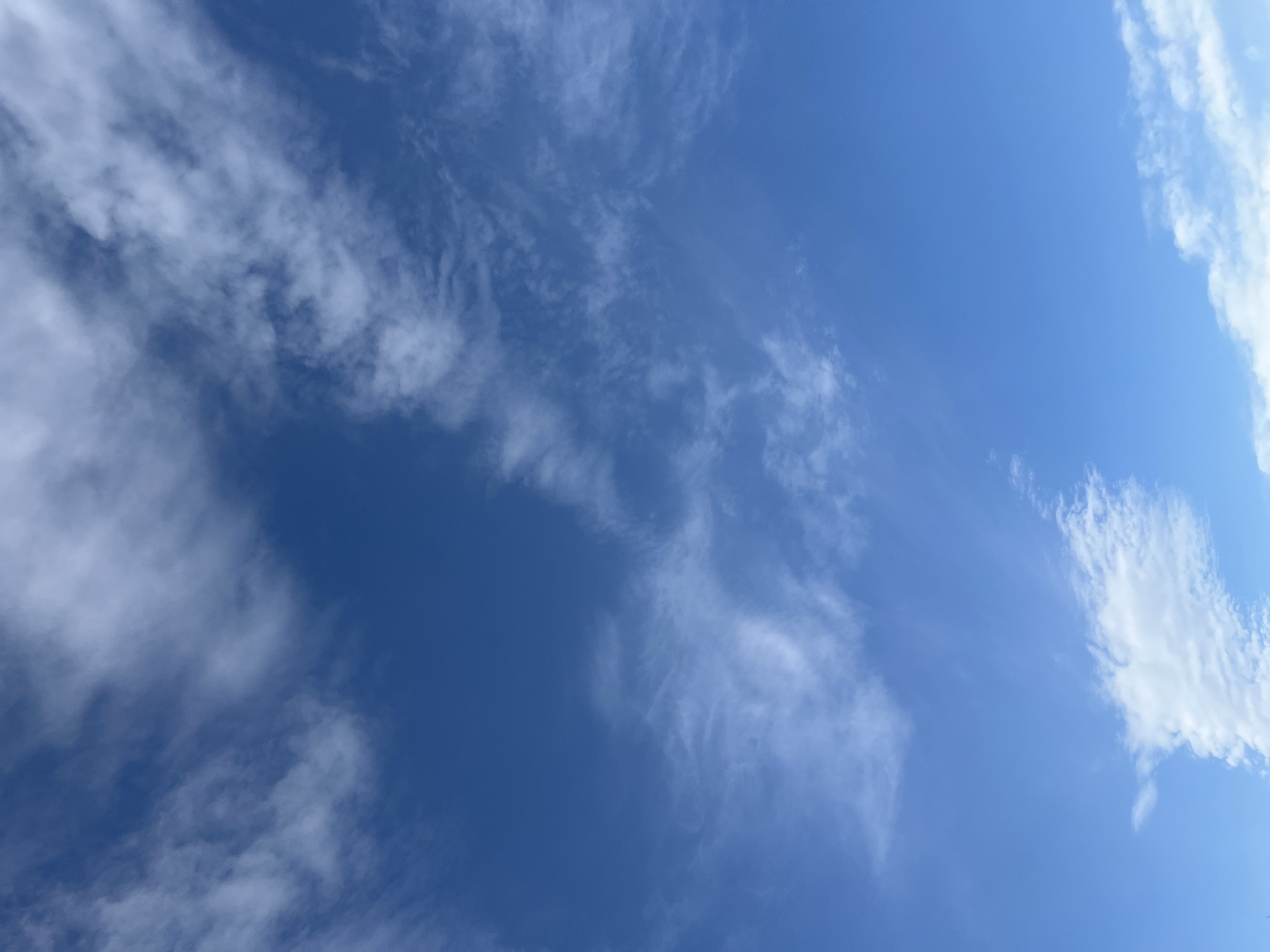 The image depicts a clear, bright blue sky with scattered clouds. The location is the Town of Montgomery, United States of America. The clouds vary in density and shape, ranging from thin, wispy cirrus formations to more substantial cumulus clouds. The overall scene is peaceful and serene, capturing a moment of calm in the sky above.