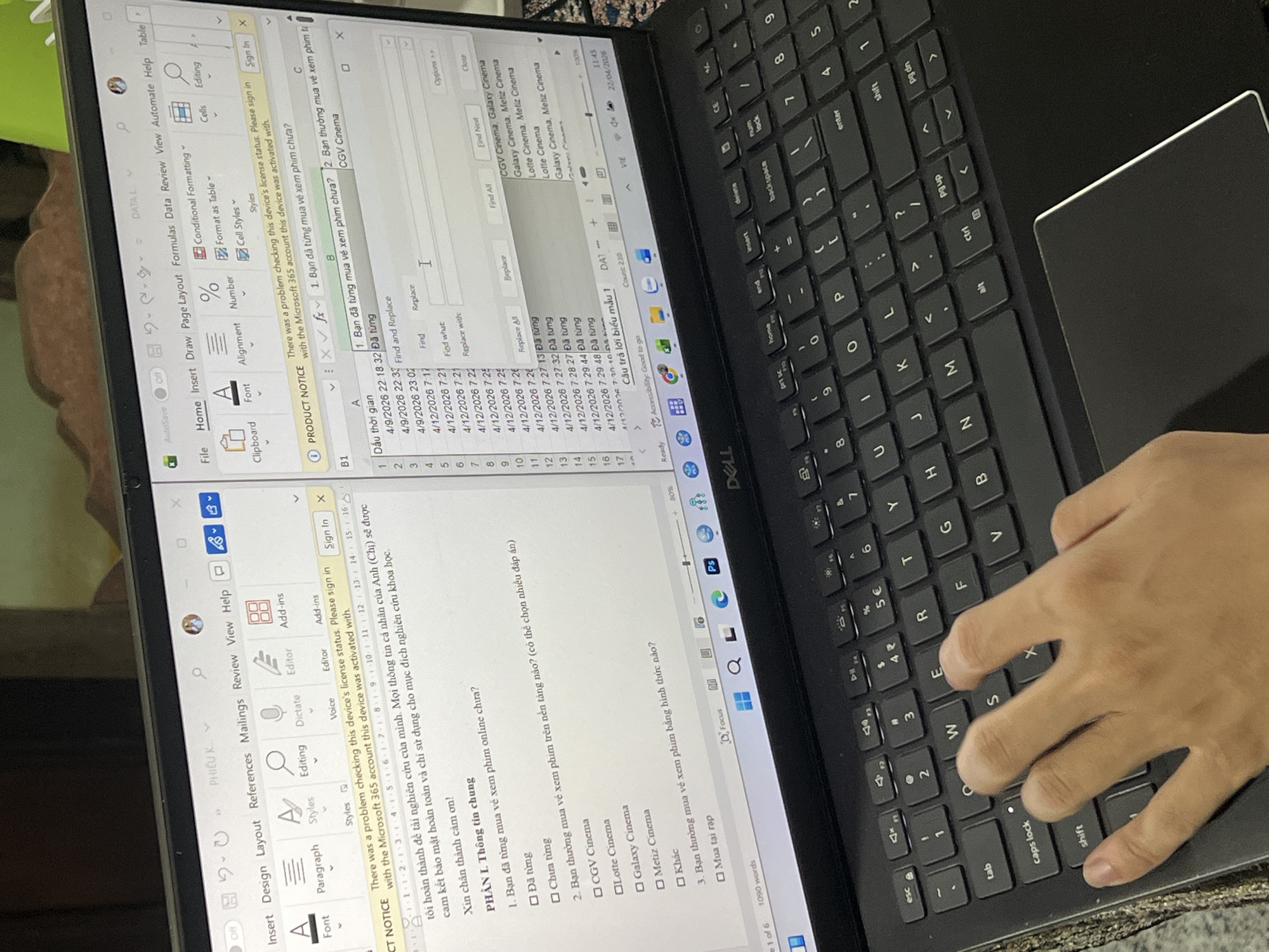 A person is using a Dell laptop. The screen displays Microsoft Word and Excel. The Word document on the left contains a questionnaire in Vietnamese regarding online movie viewing habits. The Excel spreadsheet on the right contains date and time data in column A, a Vietnamese question about previous online movie ticket purchases in column B, and movie theatre names in column C. The person's left hand is visible on the keyboard, typing. The laptop is on a dark surface, likely a table. The location appears to be inside a home or office setting, but there's no explicit information to confirm this.