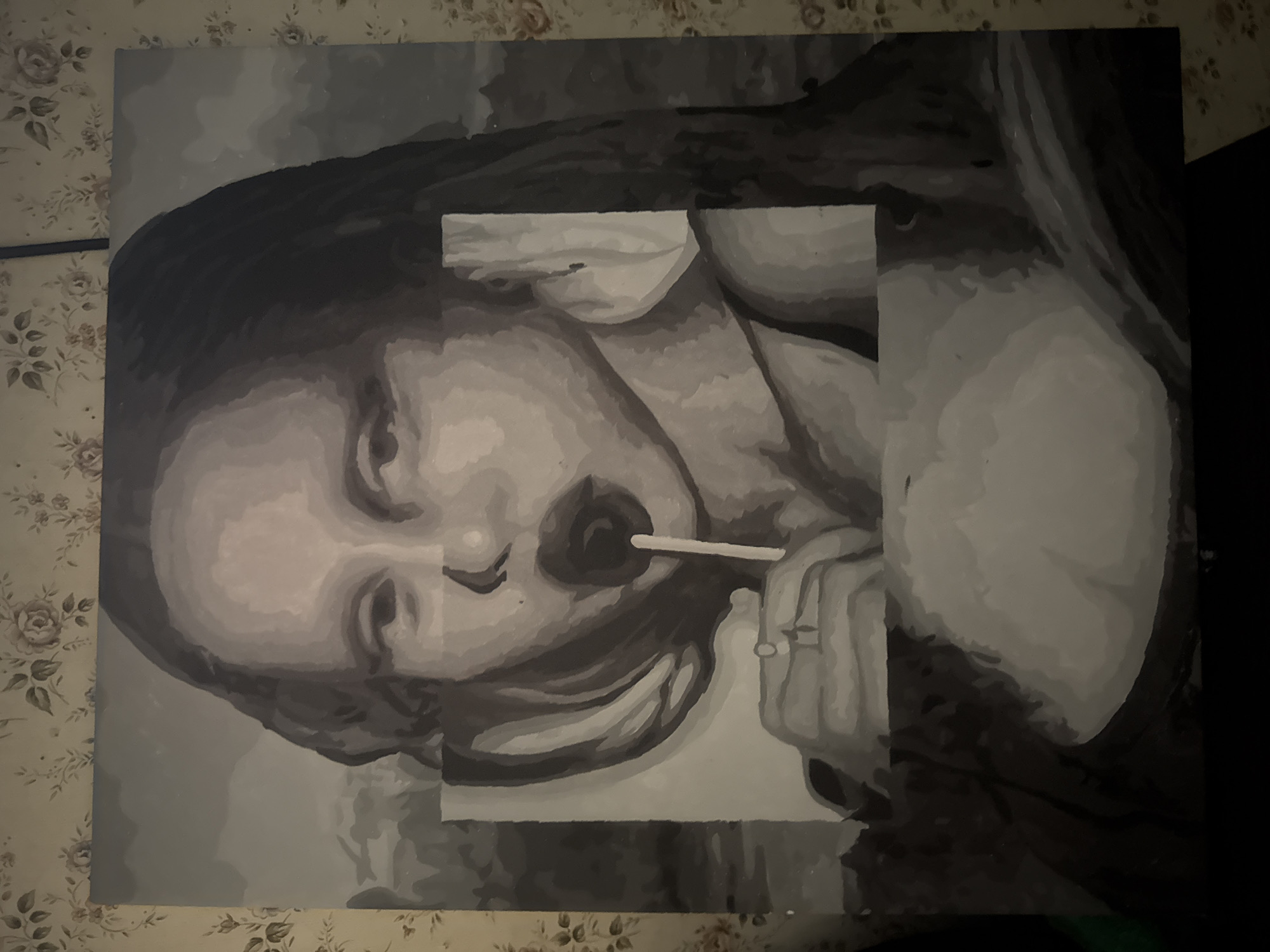 The image is a black and white painting or drawing of a young person with a lollipop in their mouth. The face is slightly tilted. The background is a patterned surface, possibly a tablecloth or wallpaper. The artwork itself has a fragmented or incomplete appearance, with portions appearing as if they have been blocked out or obscured by rectangular shapes. There is no evidence to indicate the location is in the city of Mytishchi, Russia.