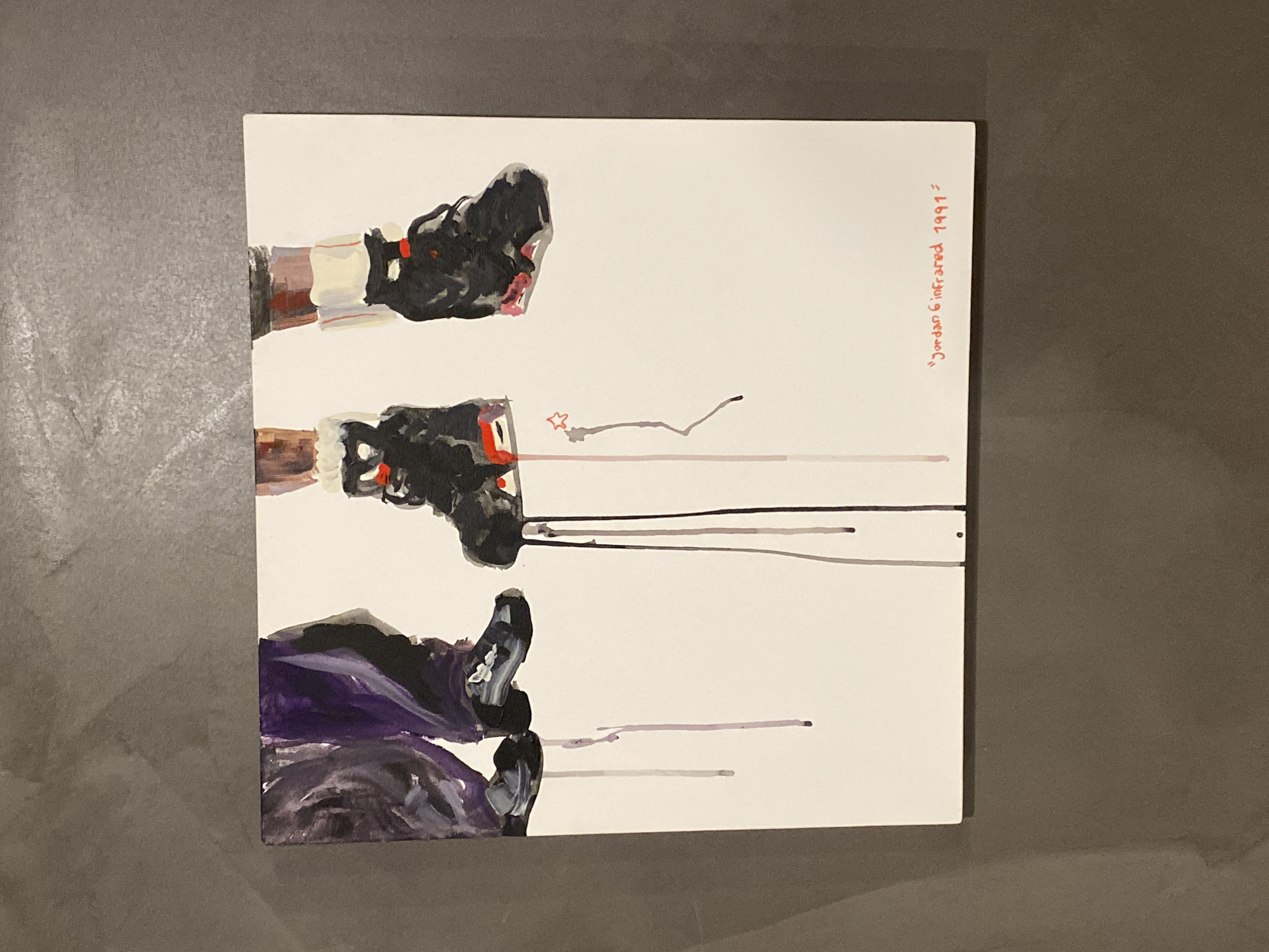 The image is a painting of three pairs of shoes. The top pair is black and white with a red detail. The middle pair is similar to the top pair. The bottom pair is black and purple. There is text in red on the right side that says "Jordan 6 infrared 1991=". The background is white. The image is resting on a gray surface. The location is unknown.