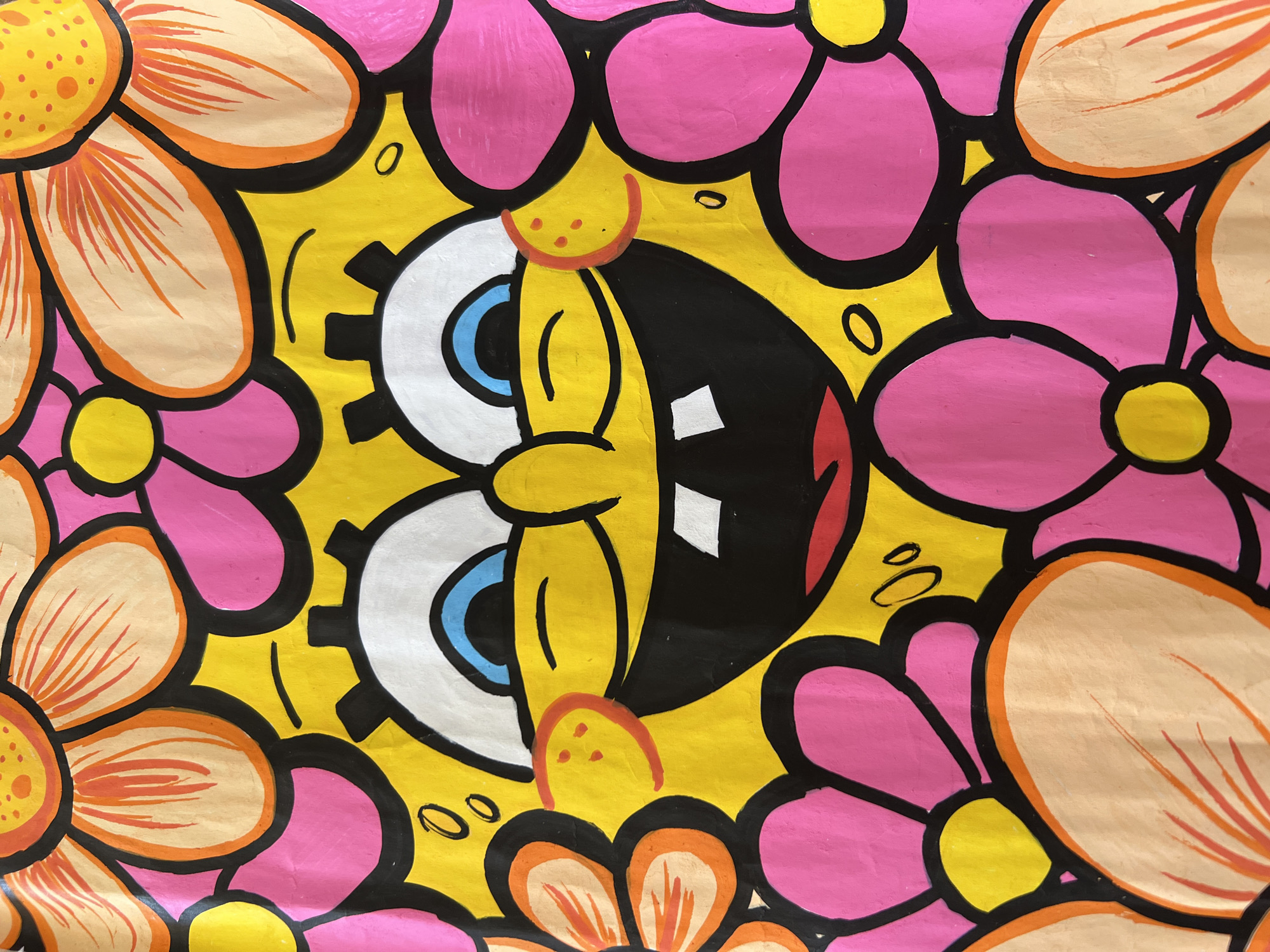 The image displays a vibrant and graphic painting featuring a stylized, yellow cartoon character surrounded by colorful flowers. The central figure strongly resembles Spongebob Squarepants, but with a more psychedelic or melting appearance. It has large, wide-open white eyes with bright blue irises; one eye features a distinctive gear-like edge. A broad, black, open mouth reveals two white rectangular shapes, possibly teeth or highlights, conveying an expression of enthusiastic joy or laughter. A small red, semicircular nose with three dots above it is visible, along with minimal lines suggesting cheeks or dimples.
The character is encased within a dense pattern of bold, black-outlined flowers. These flowers are predominantly hot pink and warm orange or peach, each with a bright yellow center. Their petals interlock, filling the background and creating a continuous, decorative frame around the central figure. Some petals show radiating lines for added detail. The painting utilizes a high-contrast color palette of yellow, pink, orange, black, white, and blue, contributing to its striking pop-art aesthetic. The texture suggests a medium like acrylic or gouache, with visible brushstrokes. No text is visible in the image. The overall scene exudes a strong sense of cheerfulness and dynamic energy.