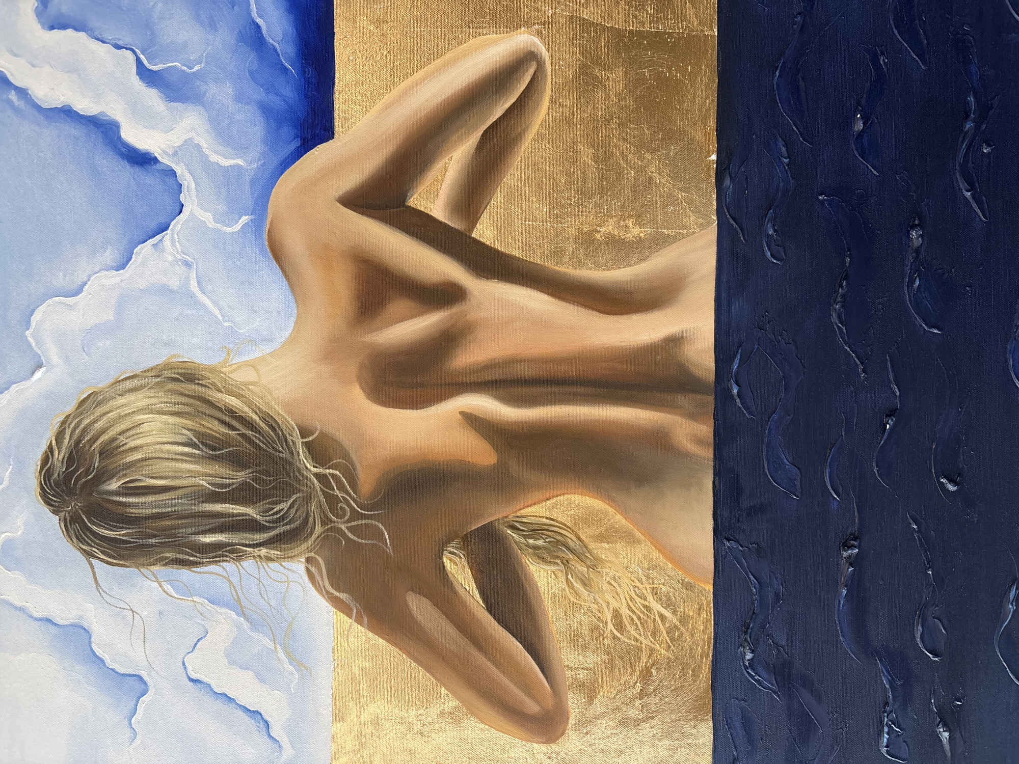 The image is an oil painting featuring a nude woman lying on her back with her head towards the left side of the frame. Her blond hair spreads out over a background of light blue sky and white clouds. Her body lies against a gold-leaf background, and a section on the right side of the painting is a dark blue color with textured, raised patterns resembling short brushstrokes or watermarks. The painting is divided into three distinct vertical sections: sky, body and gold, and dark blue texture. The woman's arms are bent, resting near her head, and her back is visible, showing the contours of her spine. The overall composition creates a contrast between the ethereal sky, the sensuality of the body, the opulence of gold, and the depth of the dark blue texture. The location in the city is Unknown, Unknown.