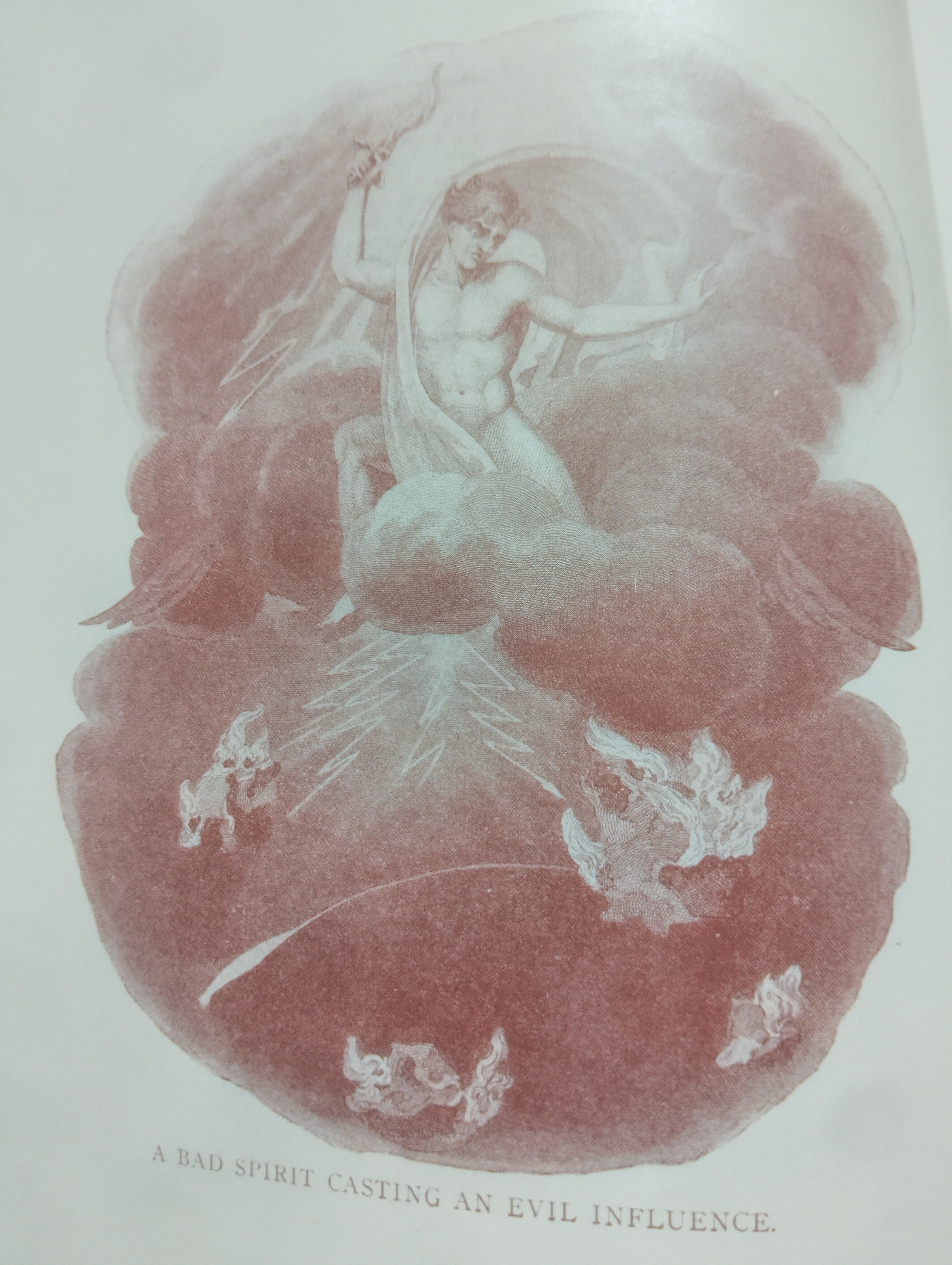 The image is an illustration depicting a muscular, bare-chested male figure in a dramatic pose, seemingly airborne amidst swirling clouds. He holds a curved object, possibly a sword or scythe, aloft in his right hand, and his left arm is outstretched. He is draped in a flowing cloth. Below him, several smaller, ethereal figures, some with wing-like appendages, appear to be descending or recoiling. Lightning or energy bolts emanate from the central figure or the surrounding clouds. The overall color palette is a reddish-brown against a pale background, suggesting an antique or artistic print. Text at the bottom reads "A BAD SPIRIT CASTING AN EVIL INFLUENCE." There is no discernible connection to Alagbado, Nigeria, or any specific urban location.